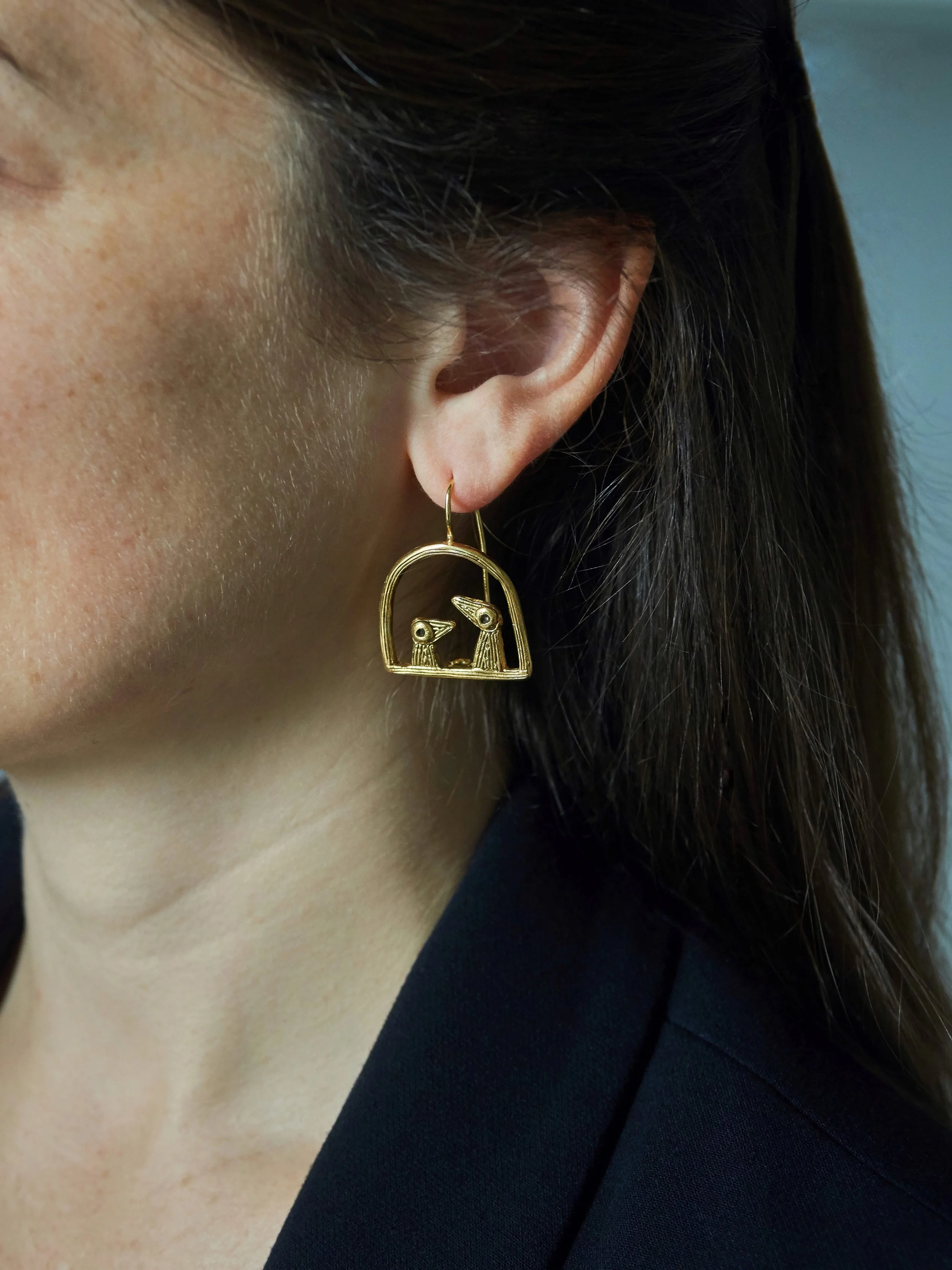 “Père et Fils” bird earrings in gold-plated bronze by Elisabeth Riveiro, worn view, Paris handcrafted jewellery