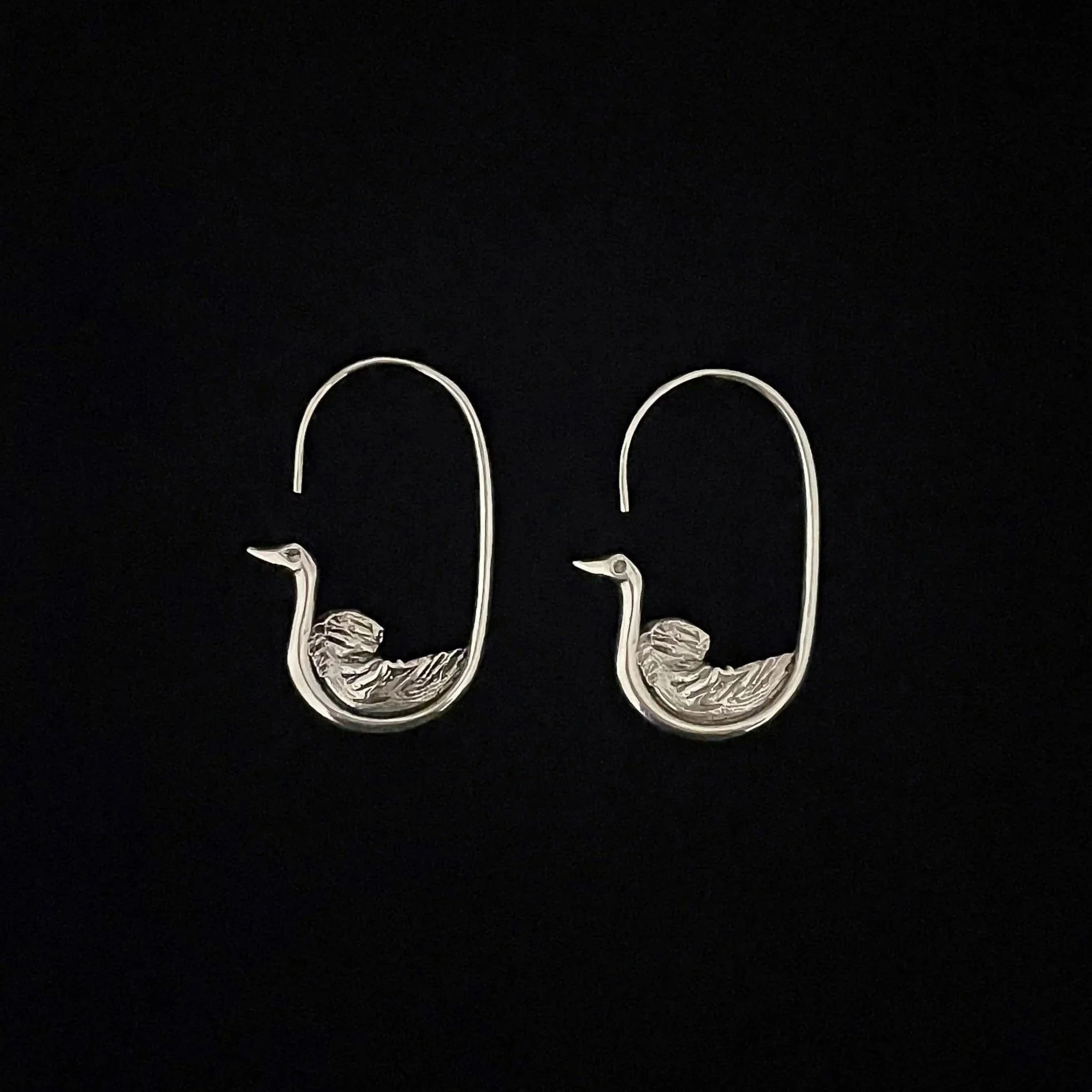 Oiseau de l’Arrivée earrings by Elisabeth Riveiro in silver-plated bronze, stylised bird design handcrafted in Paris.