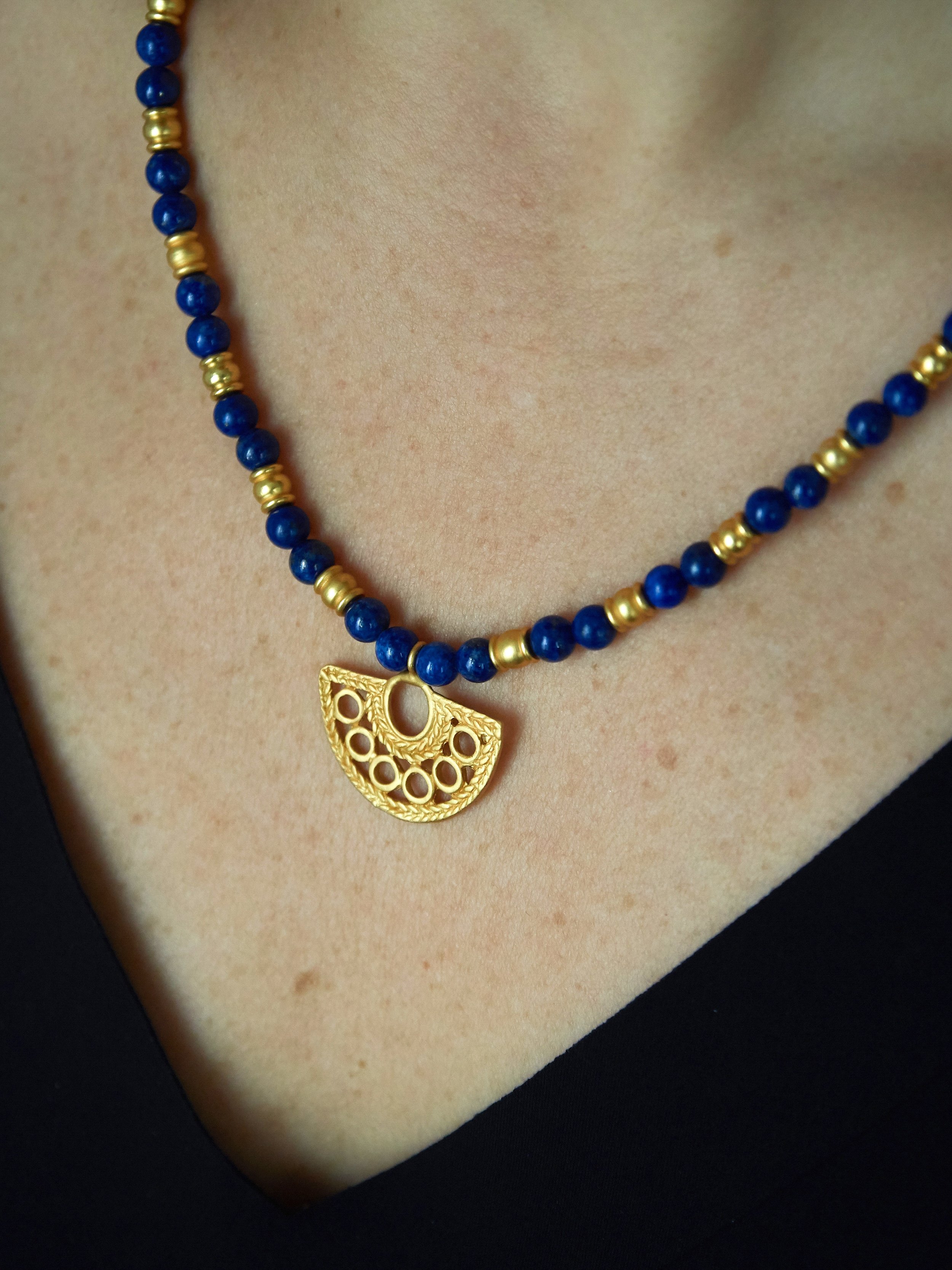 Lapis lazuli necklace with gold-plated Zenú-inspired half-moon pendant, Galeria Eldorado pre-Columbian inspired jewellery at Ambart, Palma de Mallorca.