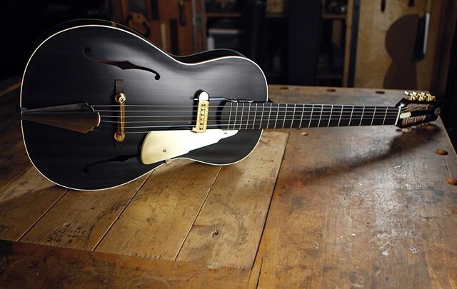 Here is a sombre shot of the last Rosetta assembled at the shop - spruce top with mahogany back and sides - matte black brushed body (sunburst neck/back) in nitro finish - all brass hardware. This guitar features an adjustable neck design (a variatio