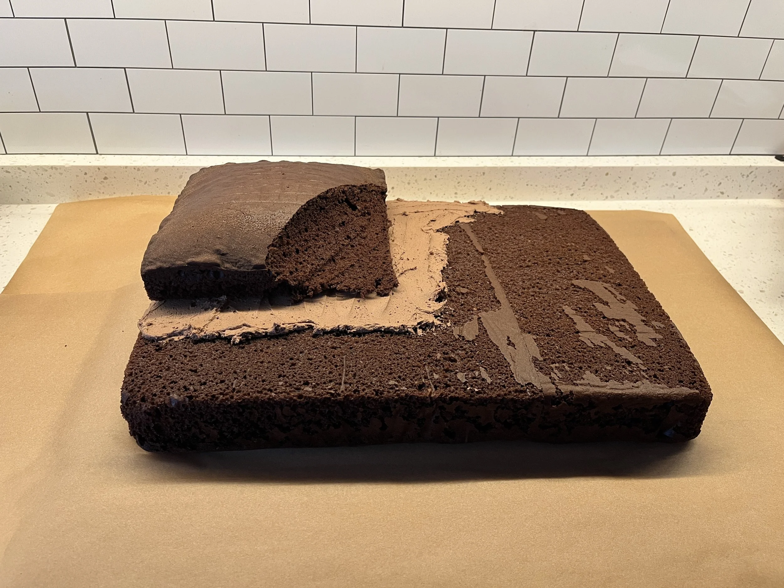 The first cut to make for your construction zone cake. This cake is two layers and has a cutout where a digger would dig.