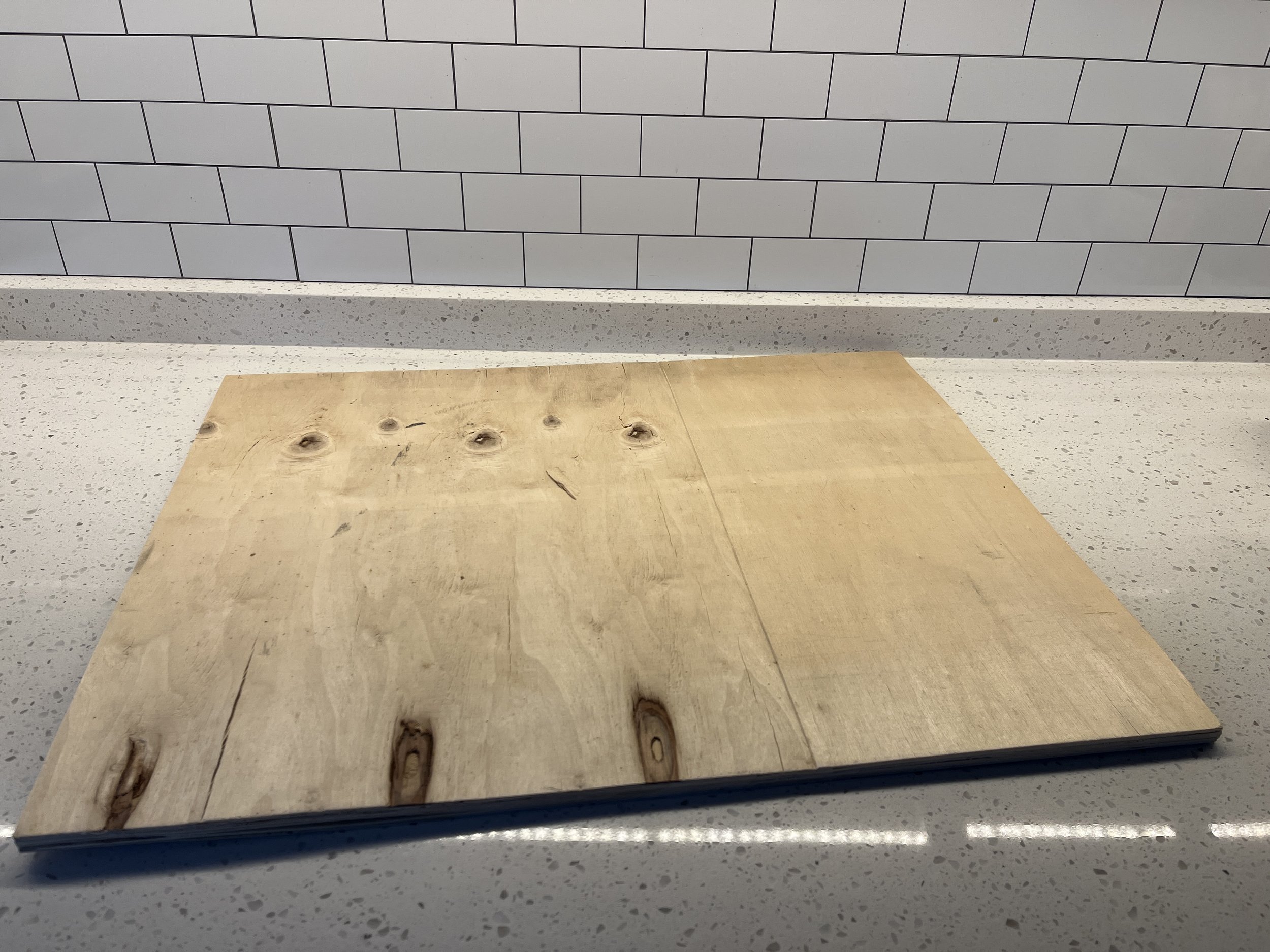 Start by grabbing a piece of plywood to use as the base of your cake. Pictures is the sheet of plywood.