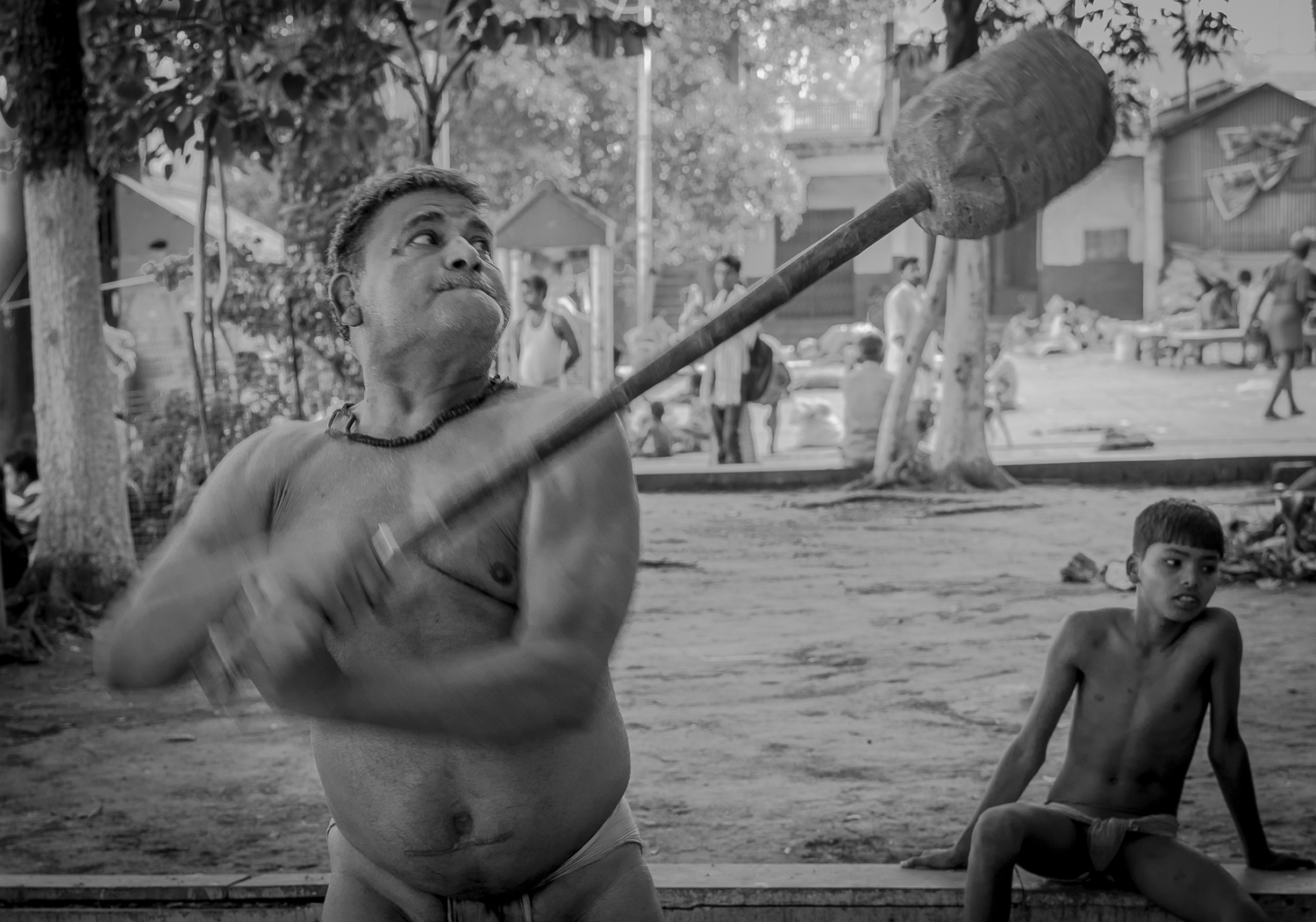 © Ayash Basu. Nandu Yadav moved to Calcutta in 1965 (he isn't exactly sure of when but believes it was around then) from Azamgarh, a small town 70 miles north of Varanasi and a known hub of criminal activity . "What's a pehlwan looking to make a living going to do in Azamgarh? So I moved to Calcutta to practice pehlwani and joined Jwala Kant Tiwari's akhara right here," he reminisces. Jwala Kant Tiwari is an immigrant pehlwan himself, having moved from Gorakhpur a few years earlier and established the akhara on the banks of the Hooghly. This akhara now houses three generations of pehlwans , who start their daily rituals at about 4:30am with a Hanuman (Bajrang Bali) prayer followed by a series of physical exercises - the mace (gada), weights, ropes, bars and aerobics. Nandu is the first one to perform the mace exercise. Having wrestled for over 30 years, he doesn't have the mobility of the younger generation to partake in all exercises or even wrestling at this stage. But, his experience, wisdom and keen eye serve to guide other pehlwans in the akhara who look up to him as their mentor.