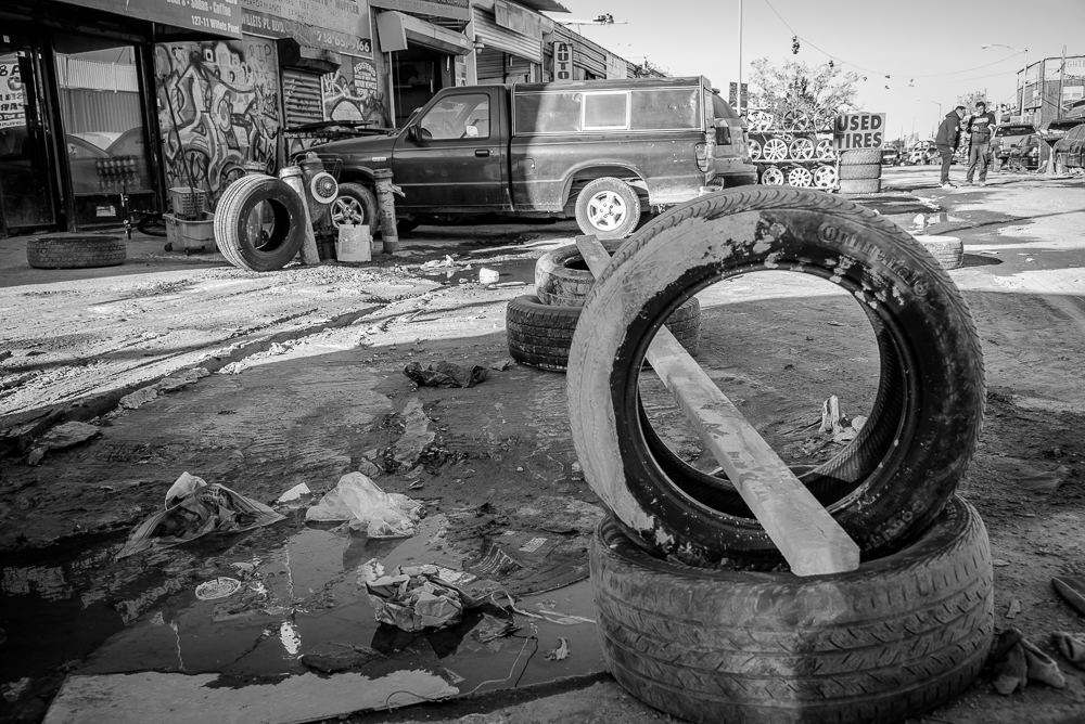 Paved roads are a rarity while drains and sewers don't exist, making access and working conditions extremely challenging. Oils and auto fluids heavy in toxins just drain down to the naturally high water table and into the bay.