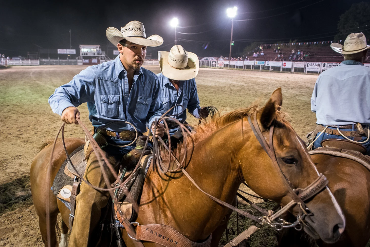 © Ayash Basu. A team just about to start a timed roping event. The beauty of ranch rodeos is the access and proximity one has to riders and animals. A 5-second prayer and off they go. Bandera 2017.