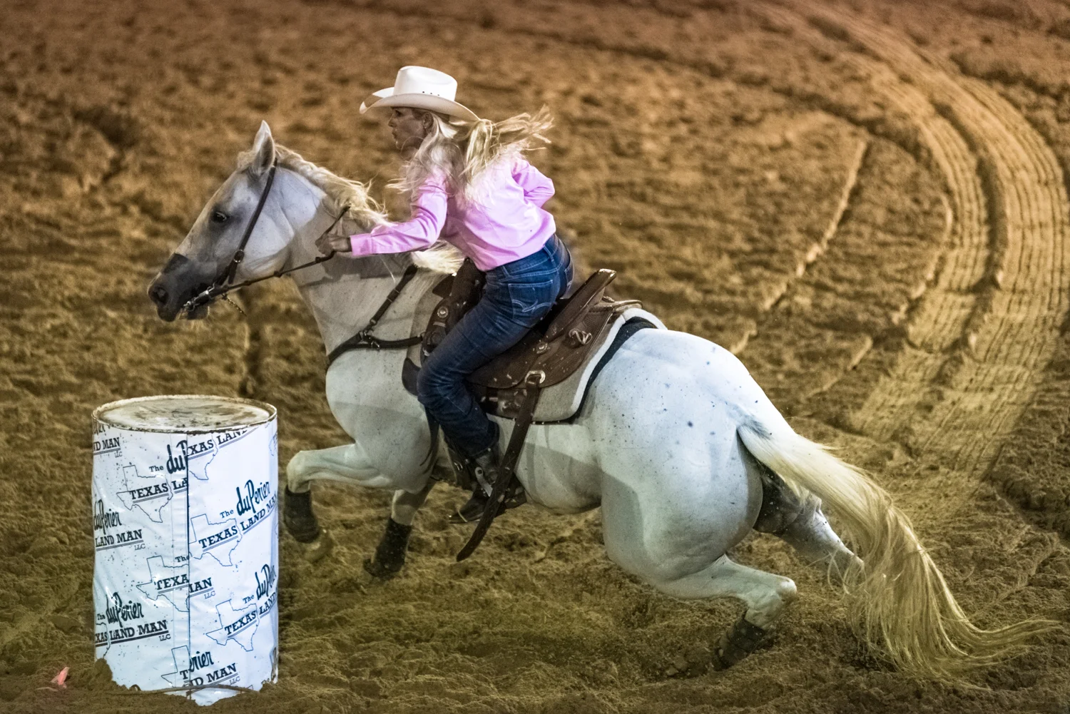 © Ayash Basu. Much like cornering speed in motor sports, "barrel hugging" is a key aspect of barrel races. Maneuvering a horse as close to the barrel as possible at high speed requires both horsemanship and physical strength, and these women are as strong as they come. Boerne 2018.