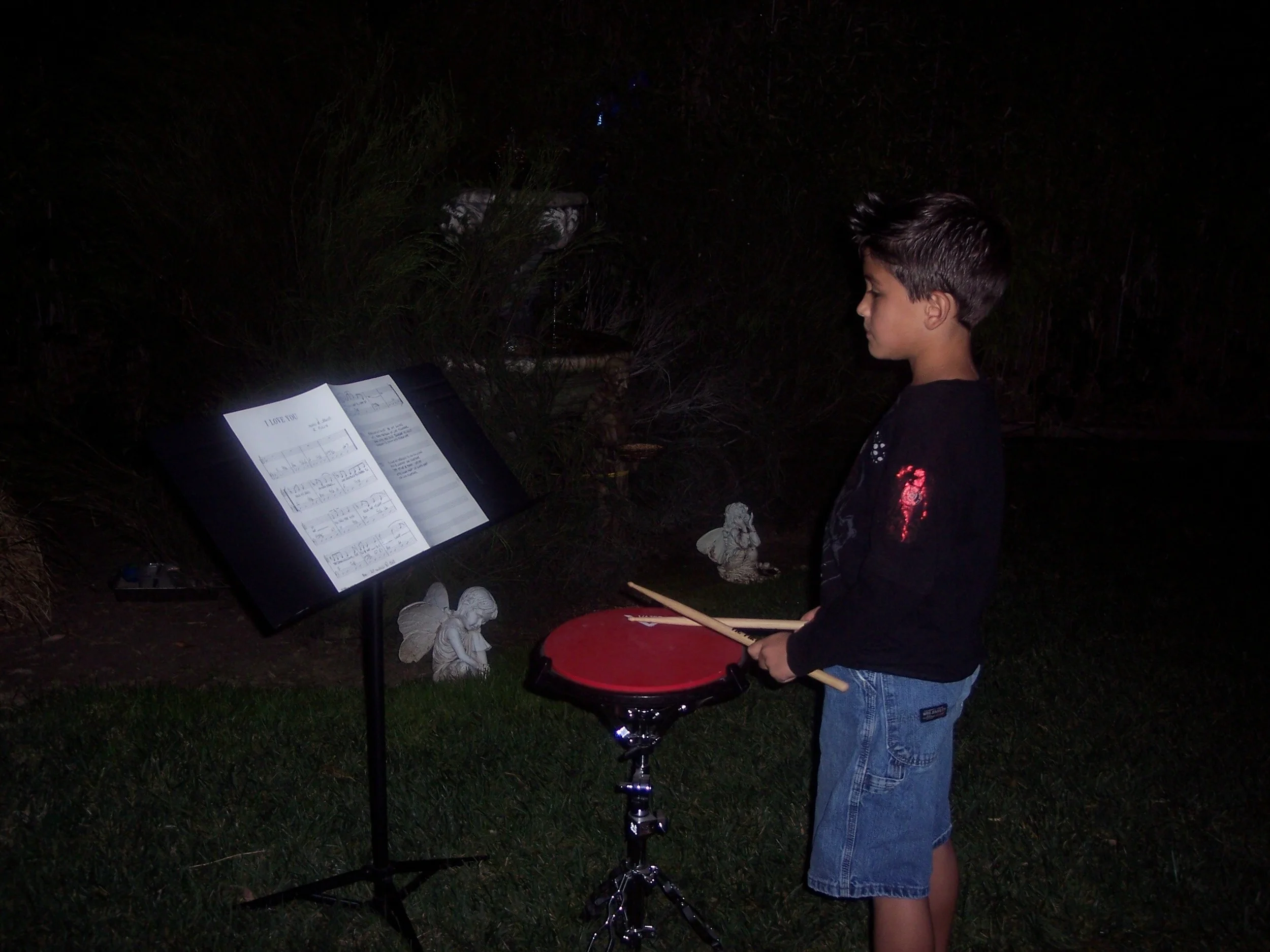Grandson Jovanny reading music and practicing drum pad
