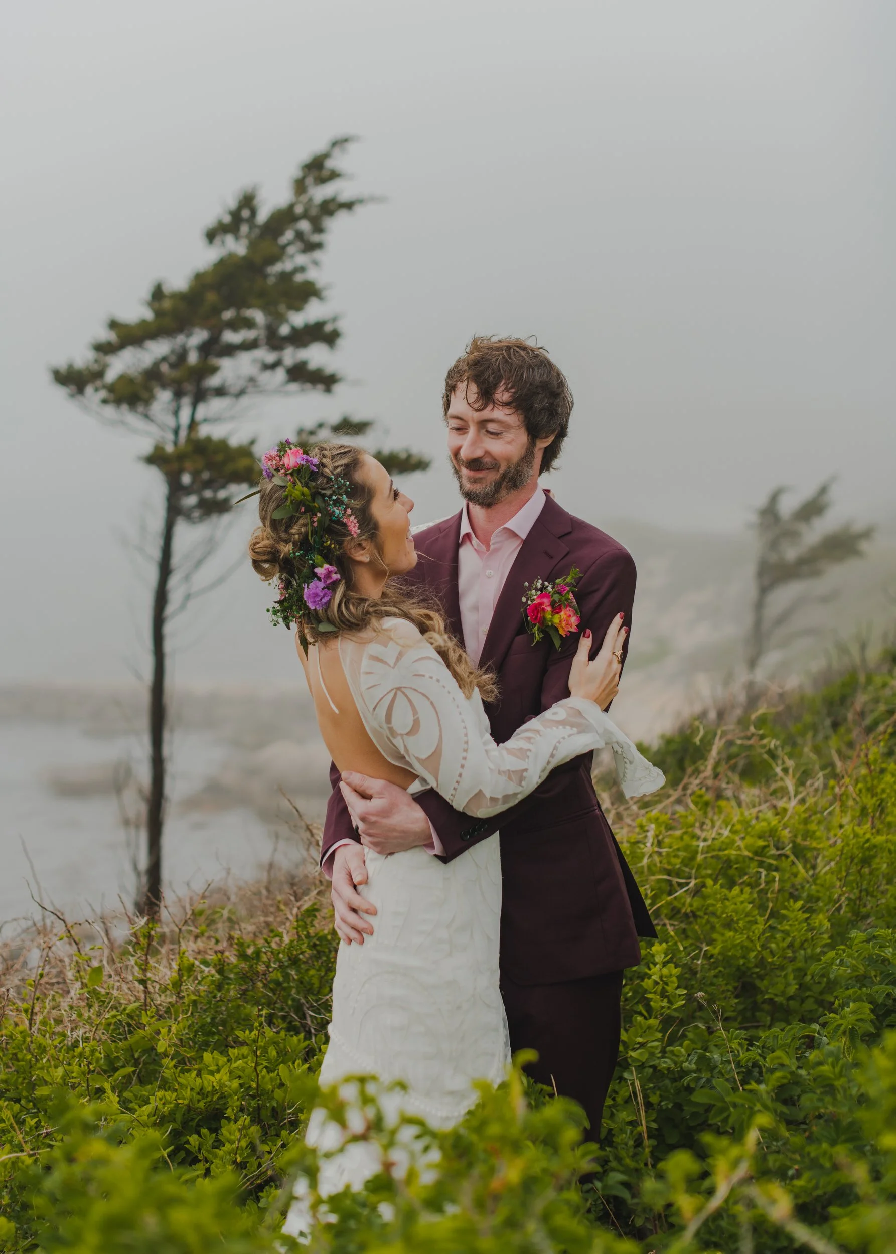 A newlywed couple dancing together in a garden