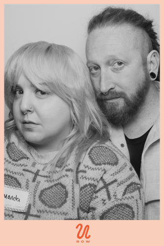 A GIF of Amanda and Mike making faces in a photo booth