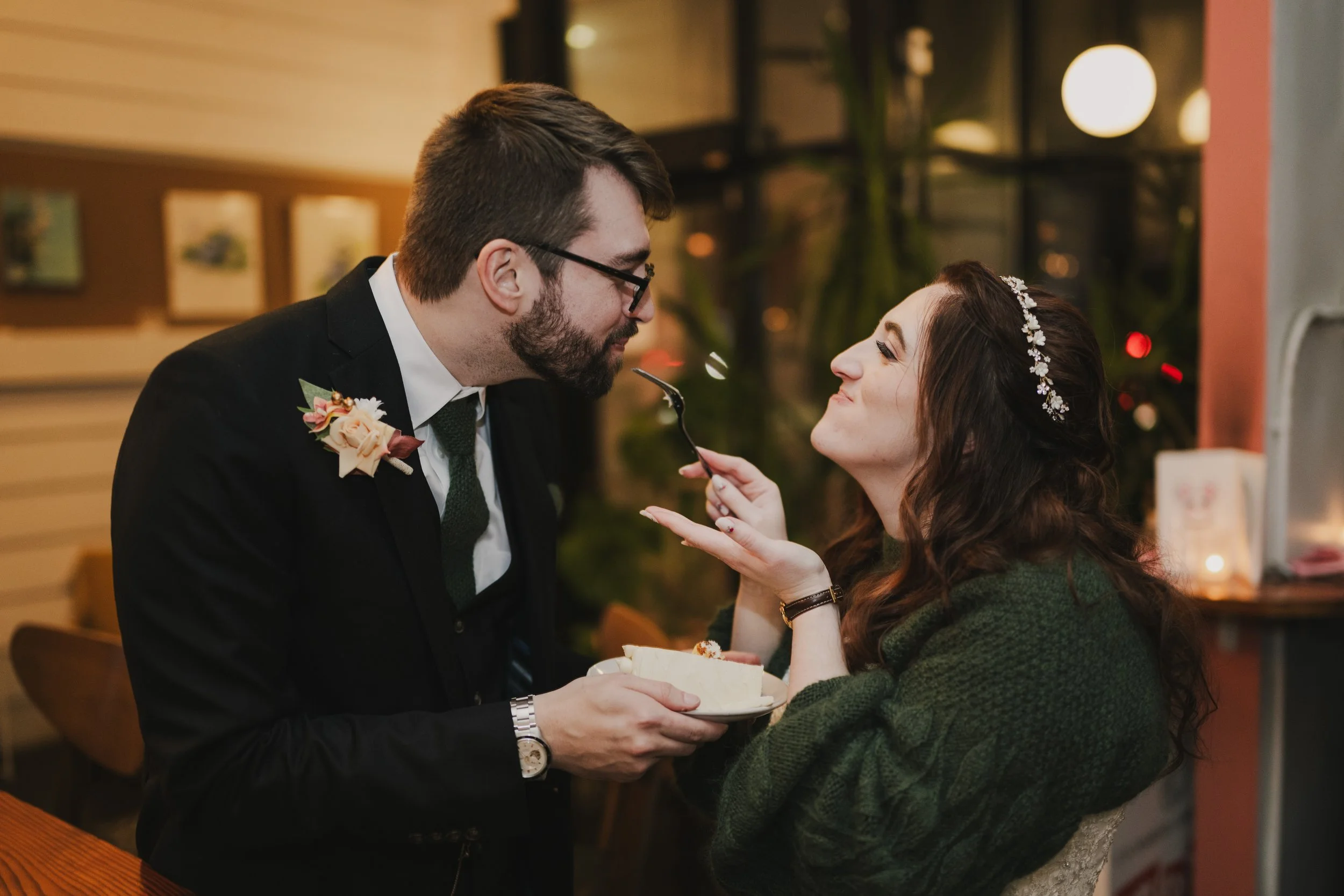 A couple feeds each other cake at their wedding reception at Juliet in Somerville