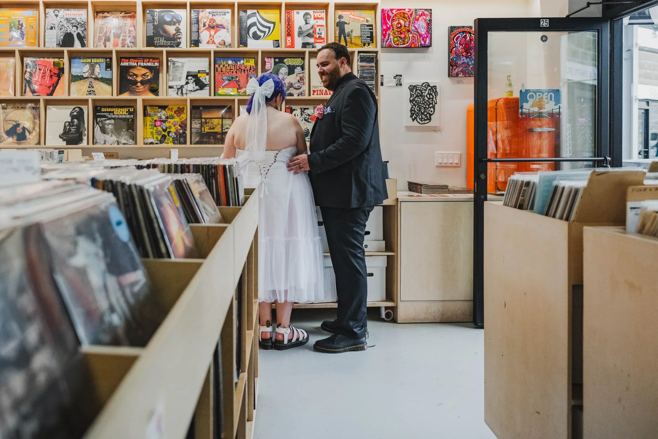 A stylish, cute couple dig for records after being pronounced husband and wife at Dearly Studio in Somerville's Bow Market.