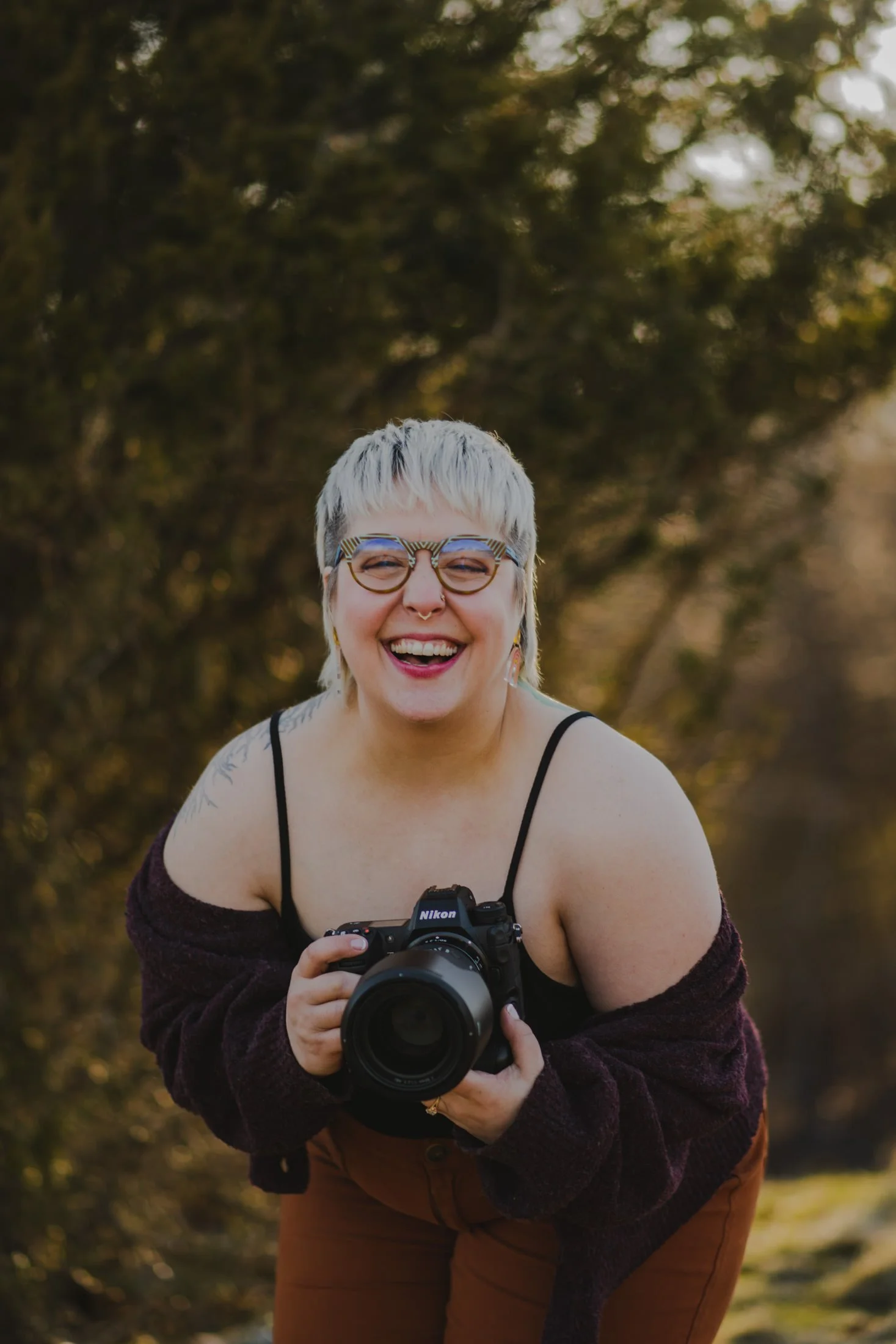 Amanda laughing while holding a camera up in front of her
