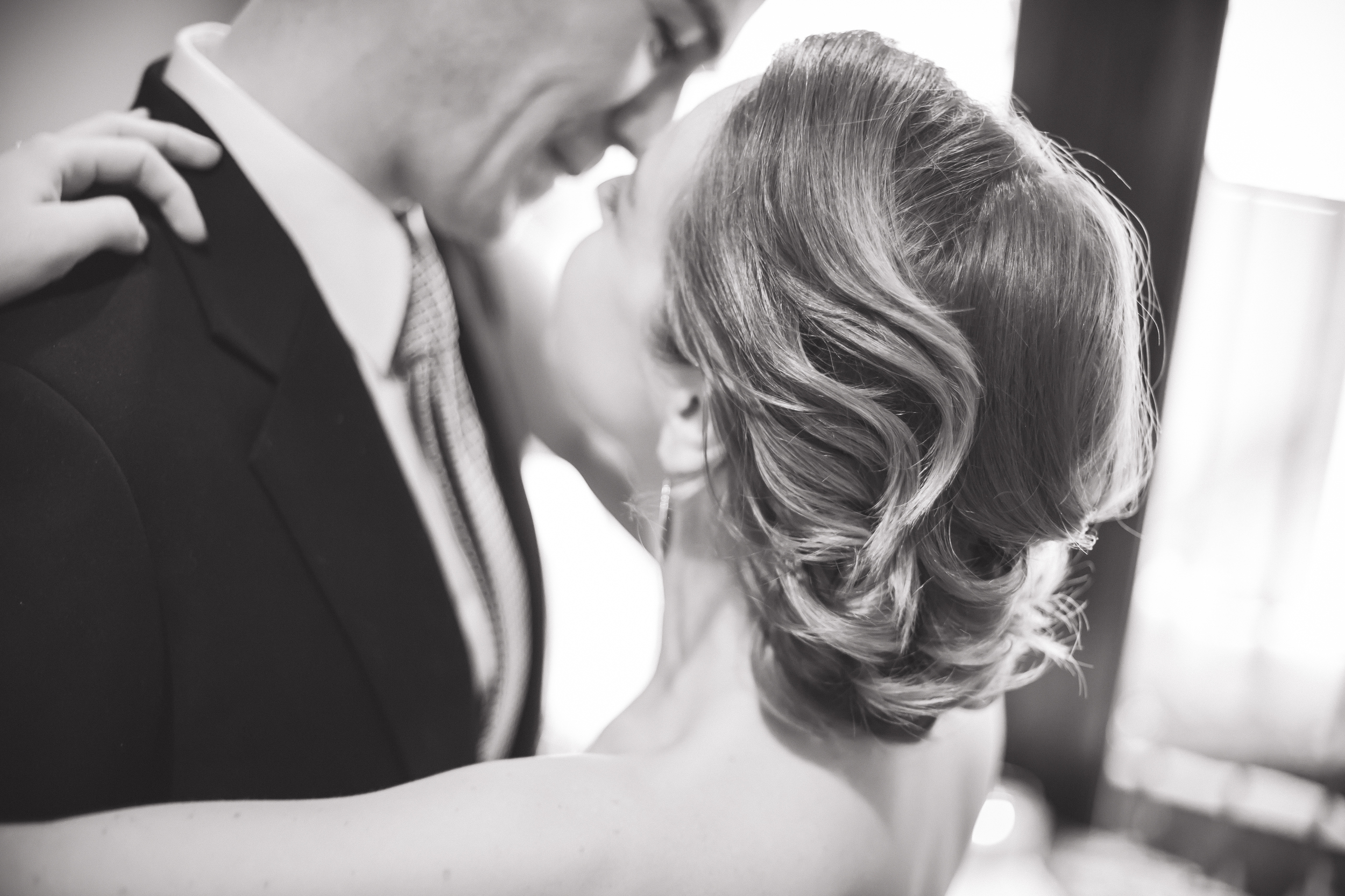 Black and white wedding ceremony photo of bride and groom