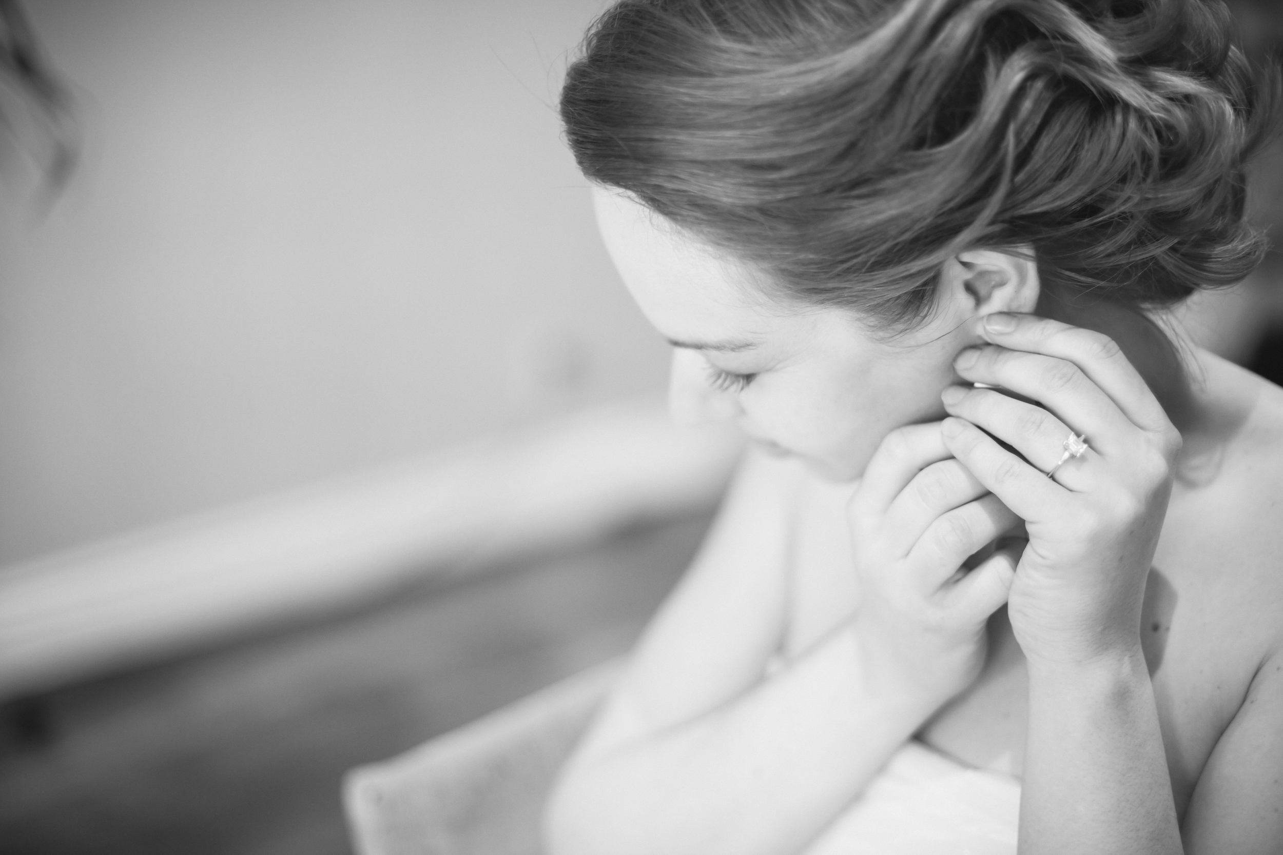 Black and white photo of bride getting ready