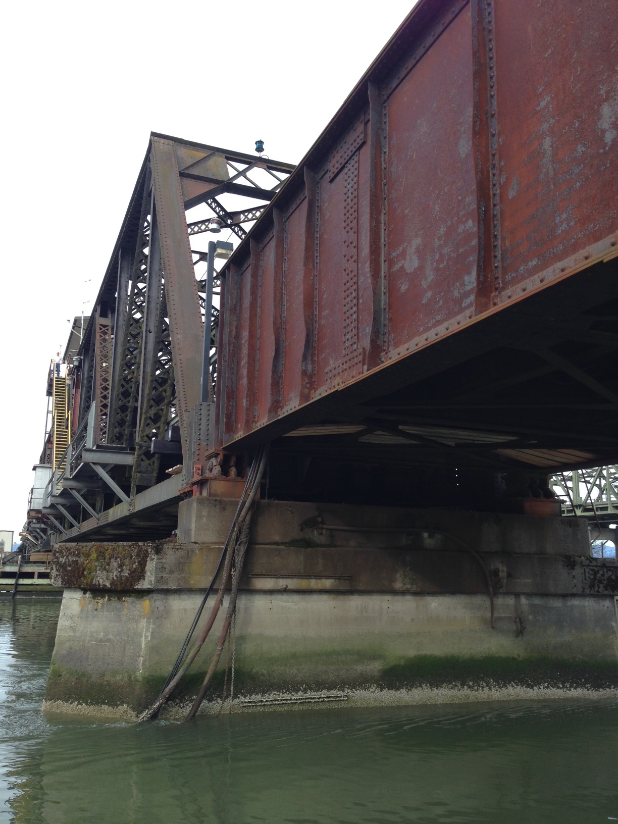 Passing beneath the railroad bridge, which must be done at low tide so as not to scrape the top of your boat.