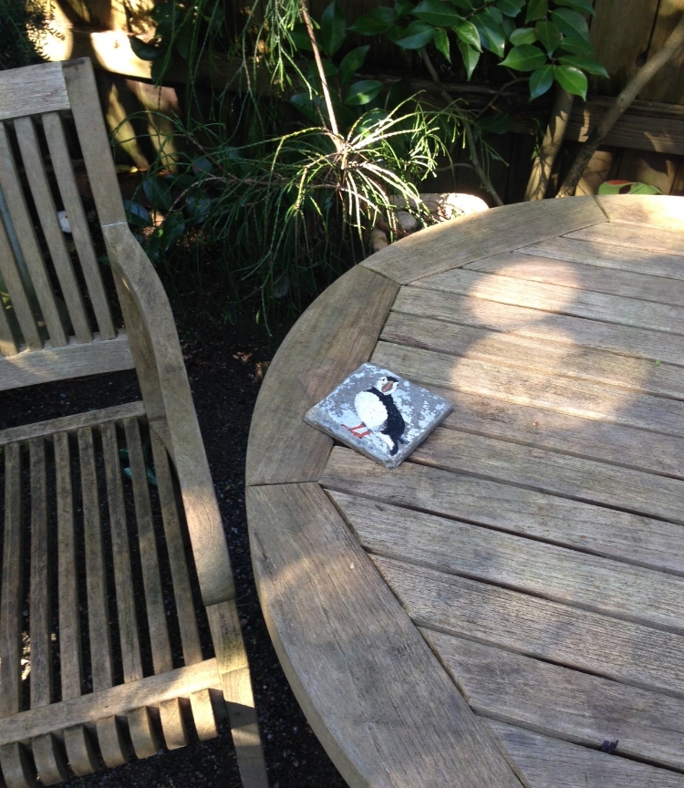 Puffin coaster on a side table.