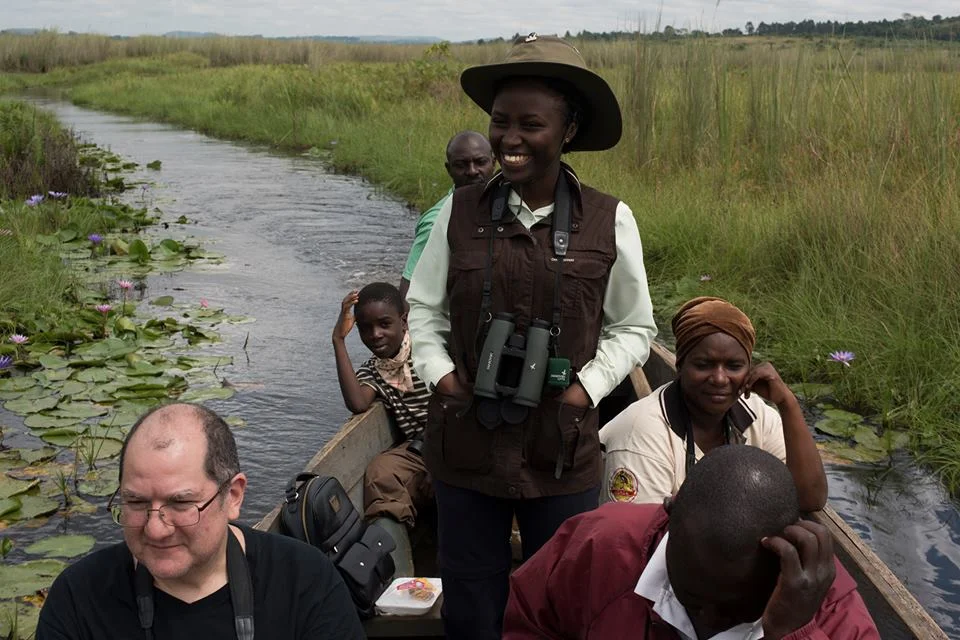 Mirembe with American client Ross Hugh and local guides at the Mabamba wetlands.