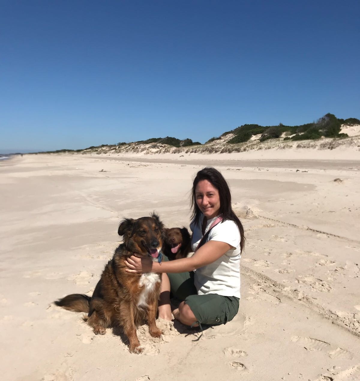 Ocampo on her home beach with her dogs Chicha and Choco.