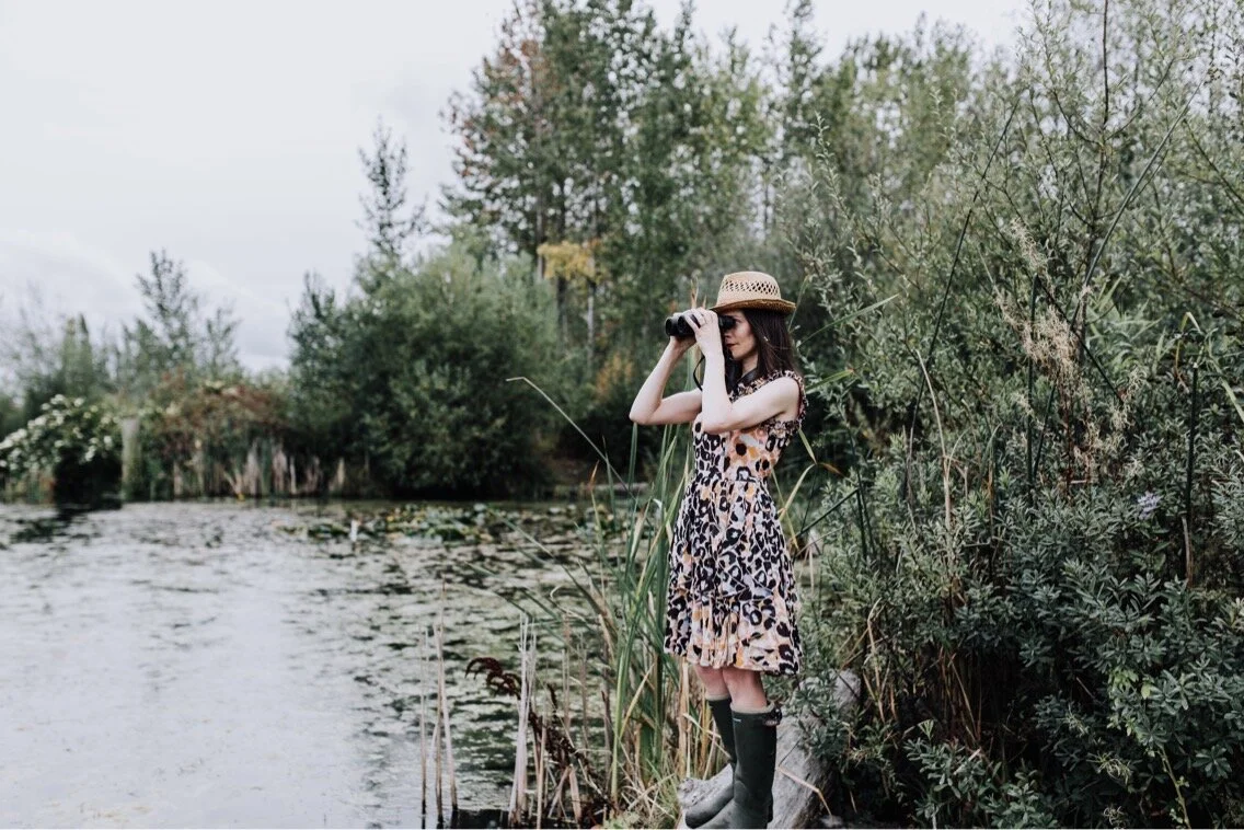 That’s me in a fancy dress, birding for real (tho’ this was a branding photo session). I saw a pied-billed grebe while posing! Photo by Dragana Lassiter.