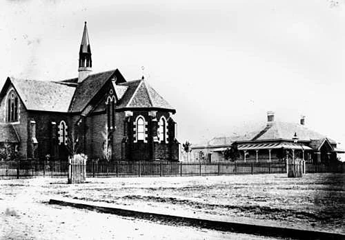 Showing the original apsidal Chancel, from corner of Mort St. + old Rectory. circa 1872 (src: Qld State Library)