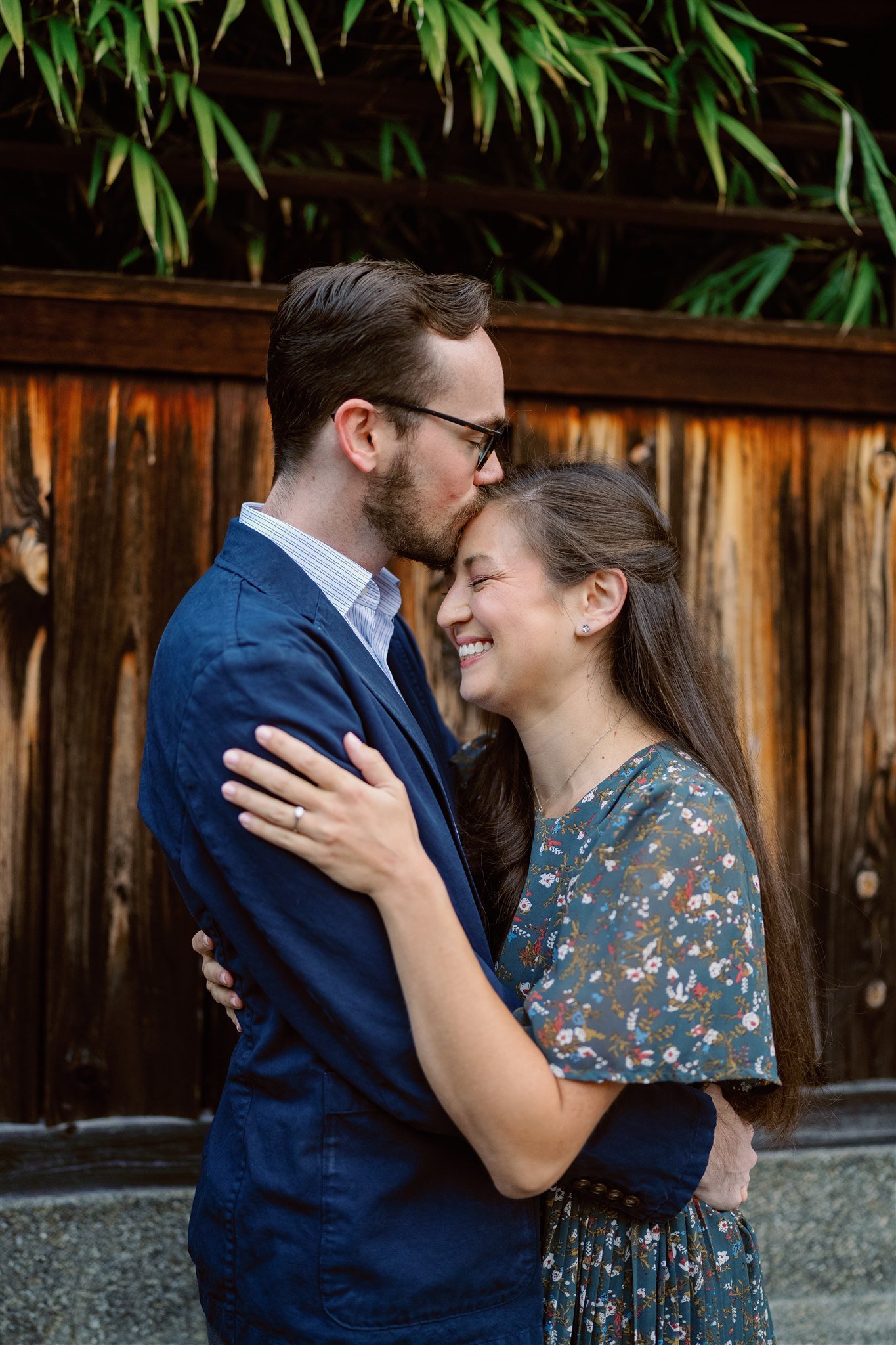 Couple kisses forehead for a special moment during their couple portrait session. 