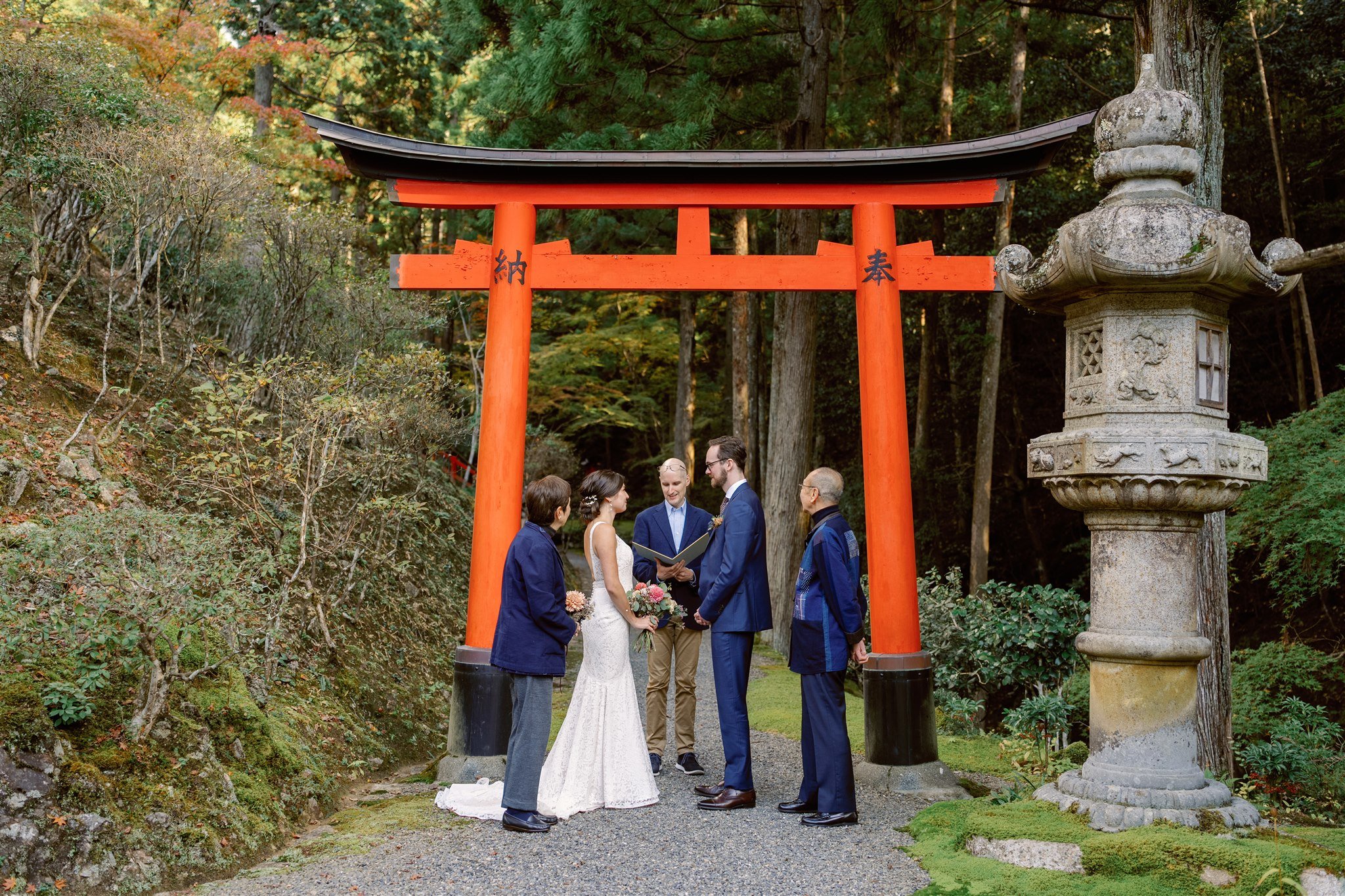 Couple under a torii gate during their wedding elopement in Japan. 