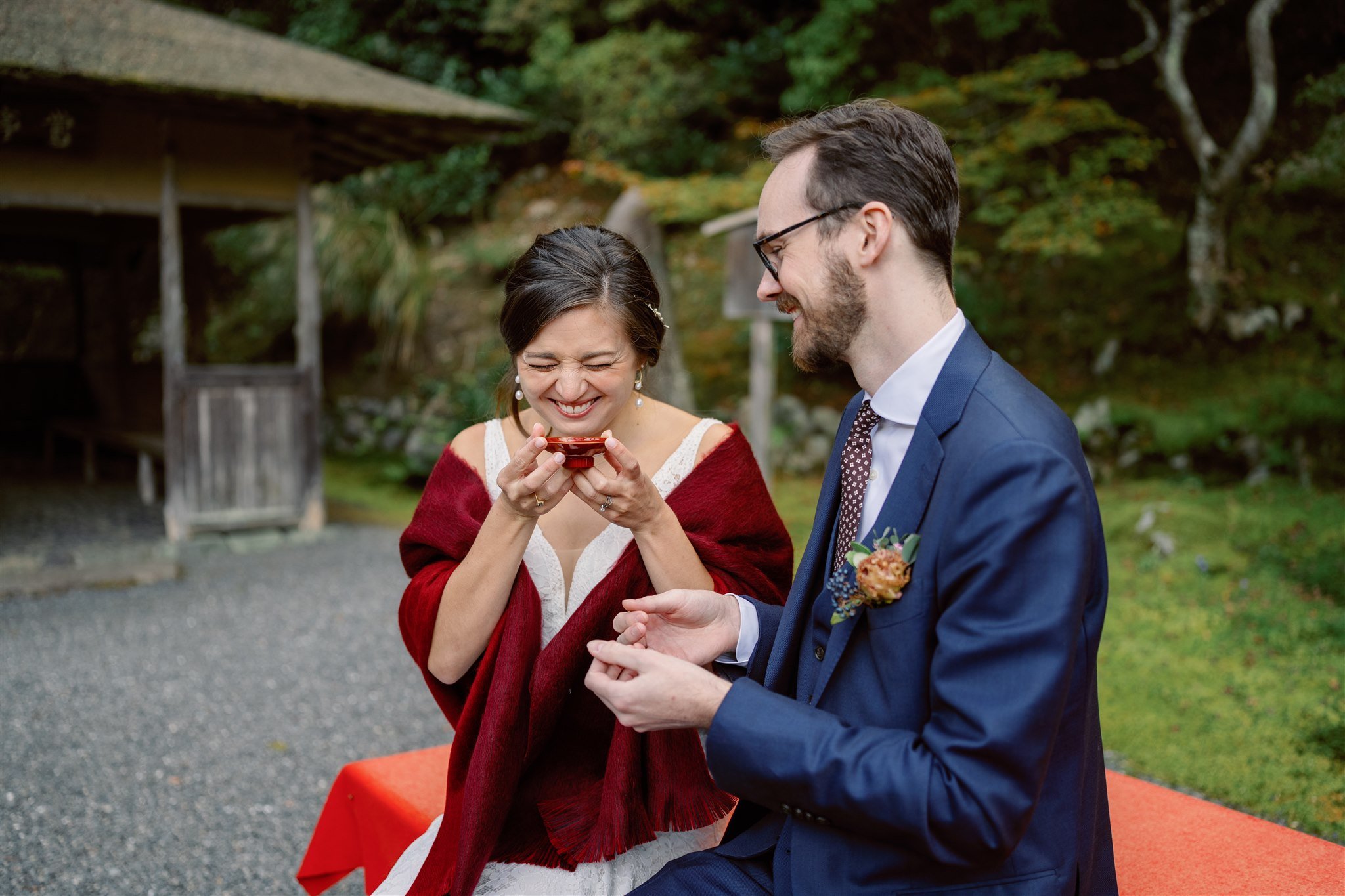 Couple drinking tea during their elopement tea ceremony. 