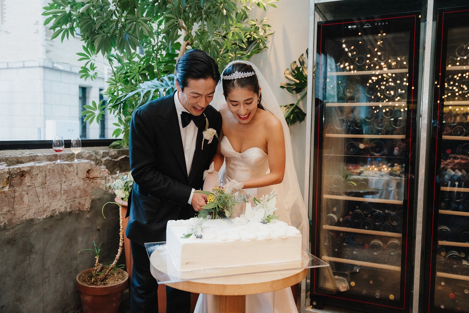  Bride and groom cut wedding cake for their trendy Tokyo wedding.  
