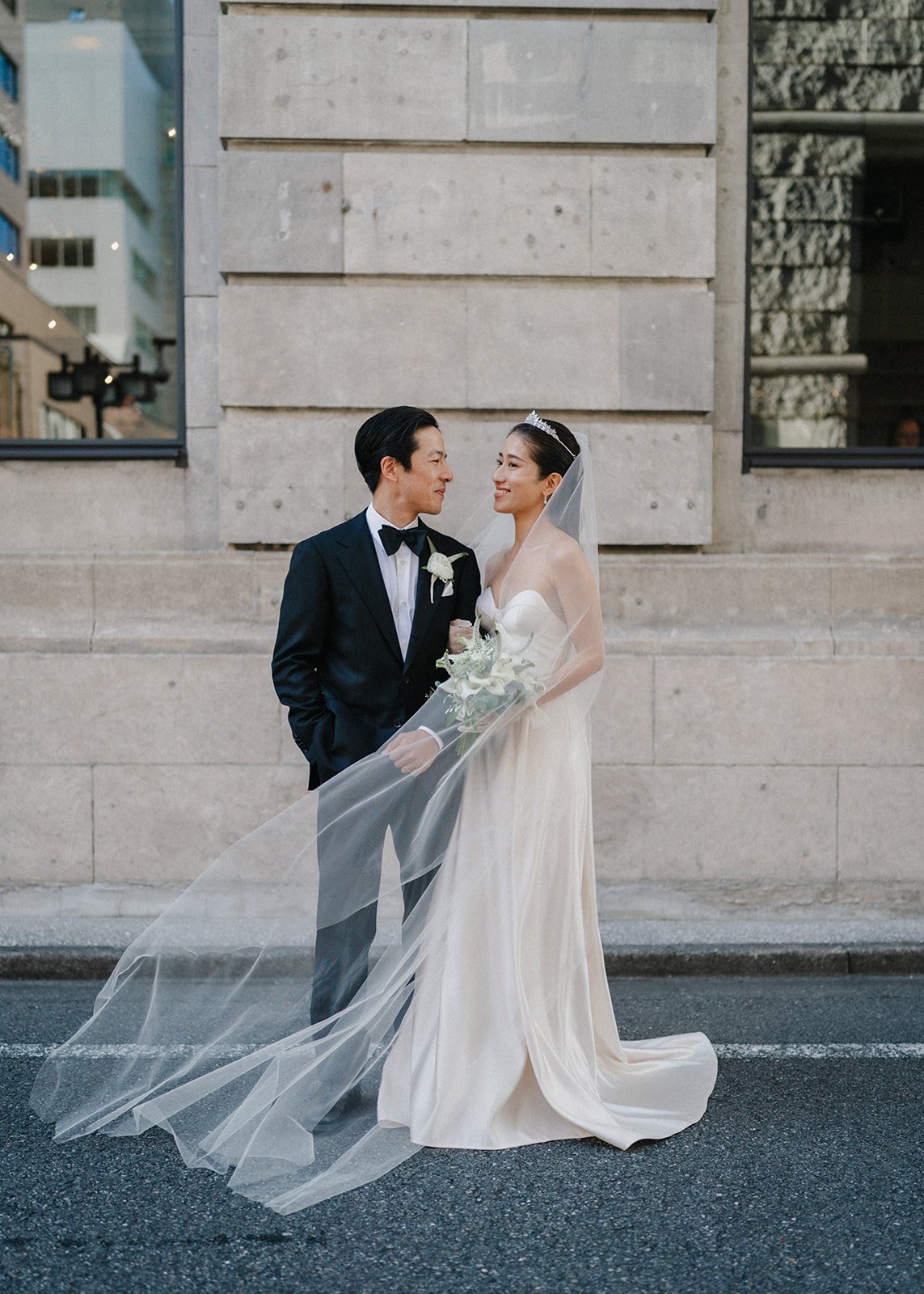  Bride and groom share a moment after their trendy city wedding.  
