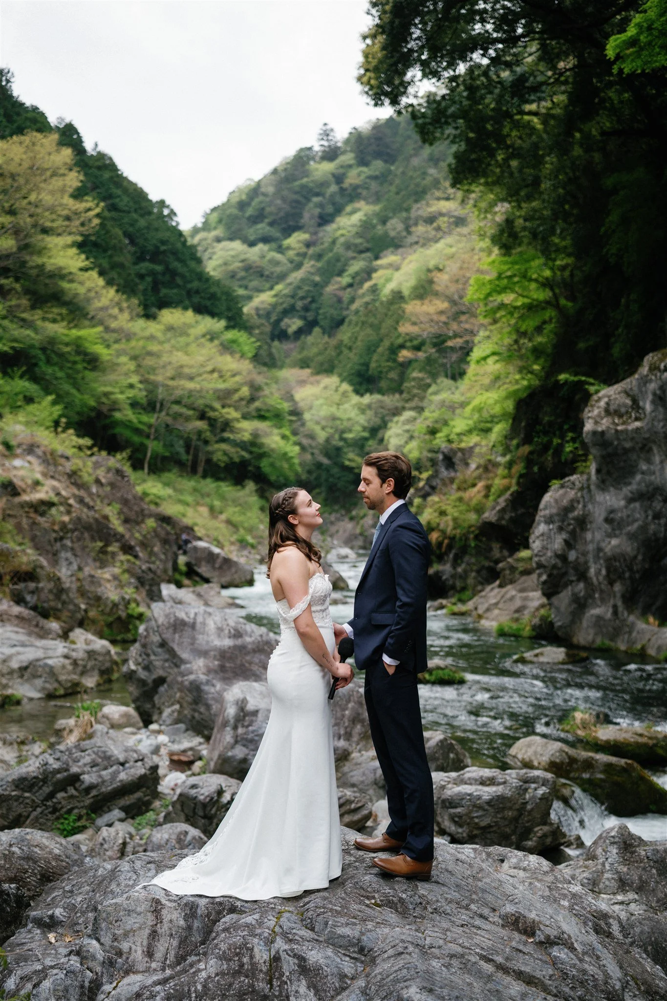 Adventure elopement couple standing on river gorge.