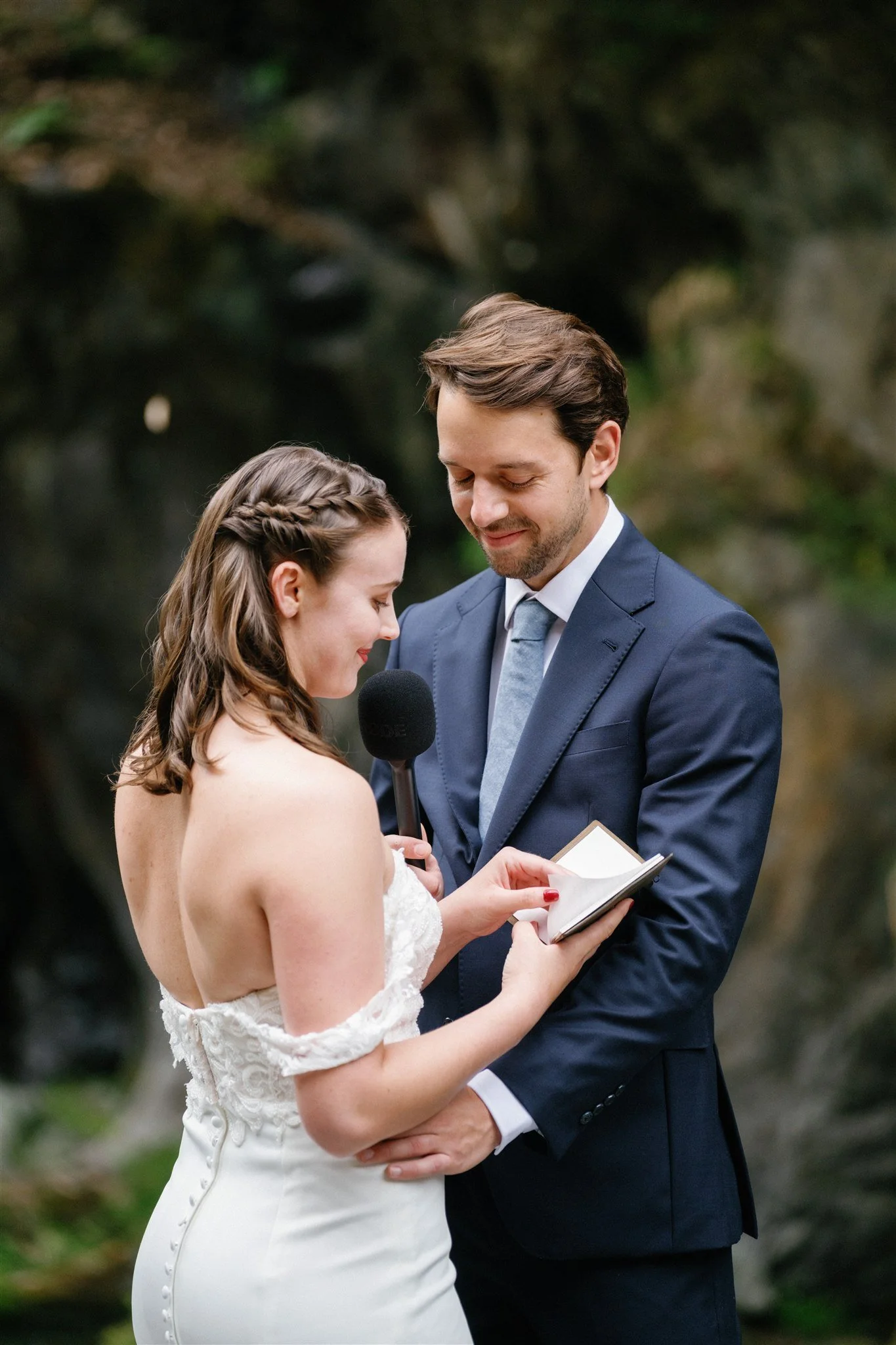 Reading vows on the river bank at their adventure elopement in Tokyo.