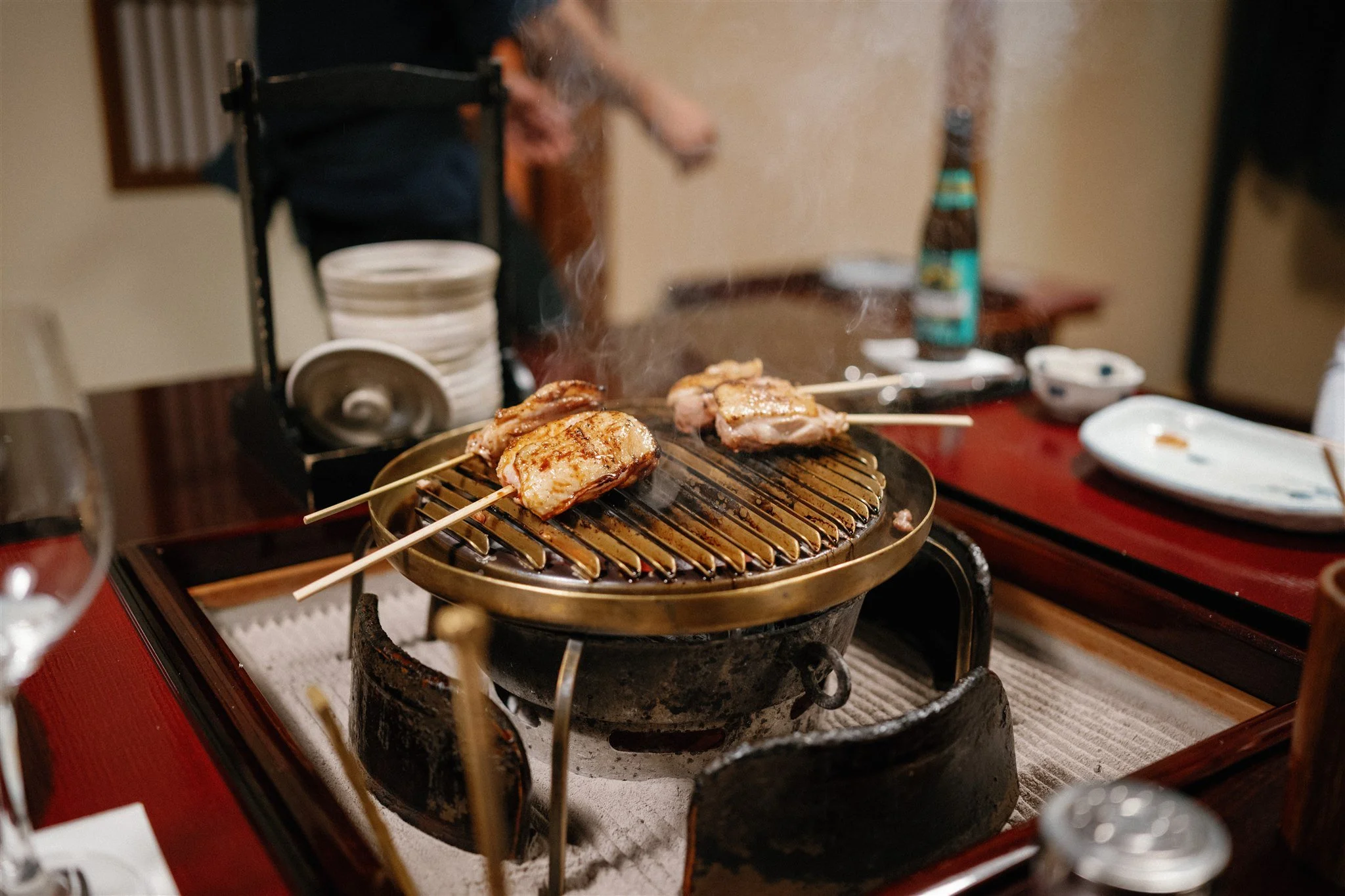 Elopement couple in Japan enjoy traditional Japanese cuisine.