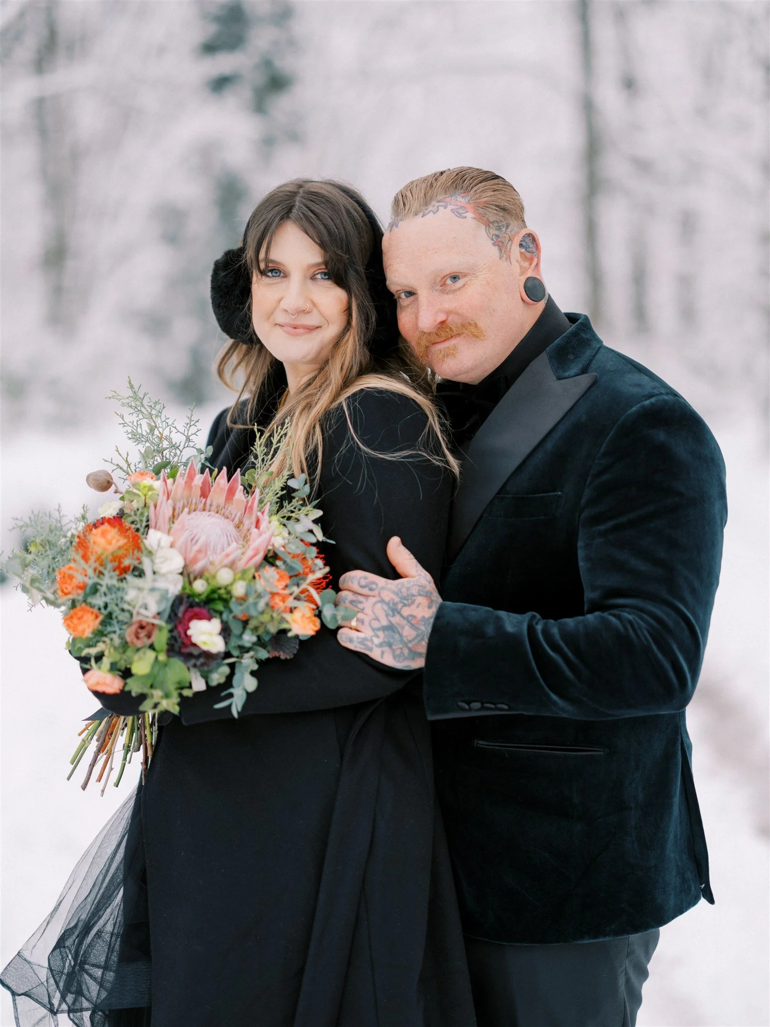 Couple portrait in snowy Nagano forest during elopement