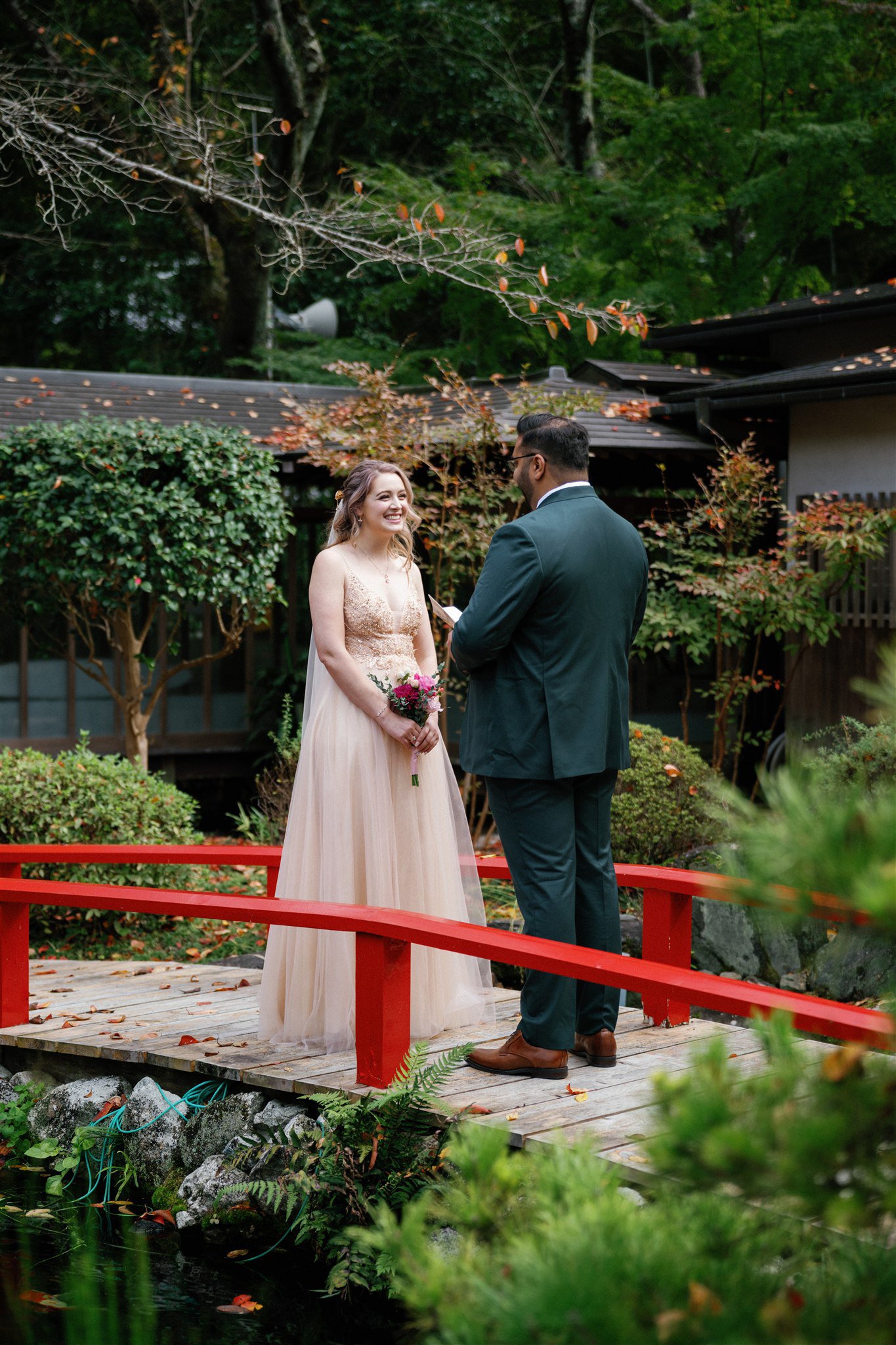  couple exchanging vows beside koi pond in Japan 