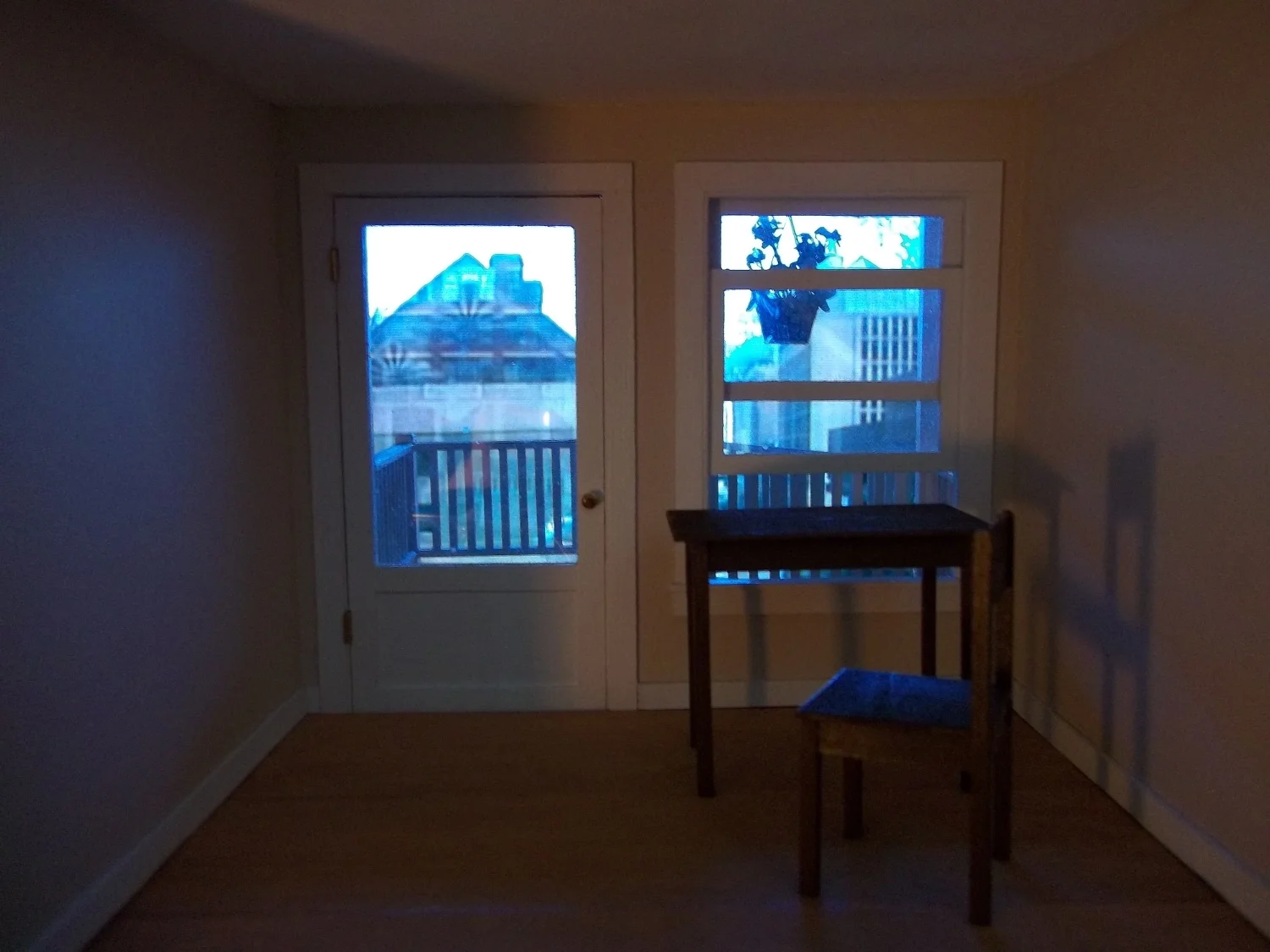  View through peephole. Video backdrop beyond window transitioning between locations. 