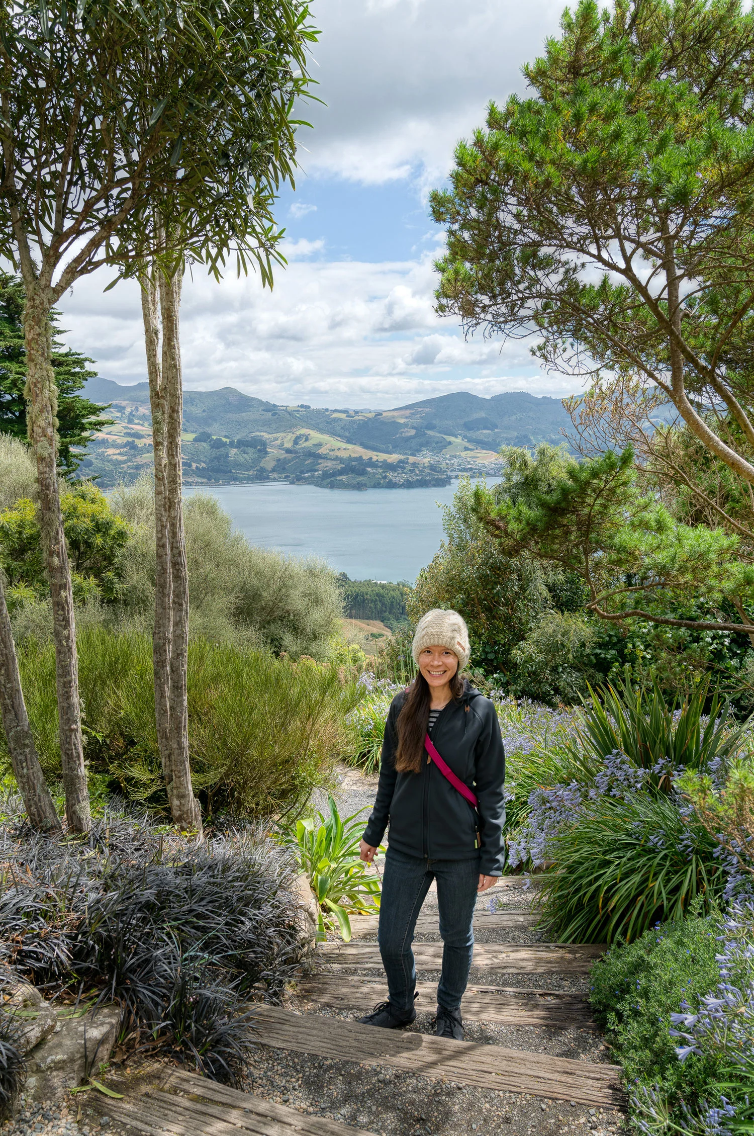 Thaneeya McArdle on the grounds of Larnarch Castle in New Zealand, overlooking Otago Harbour