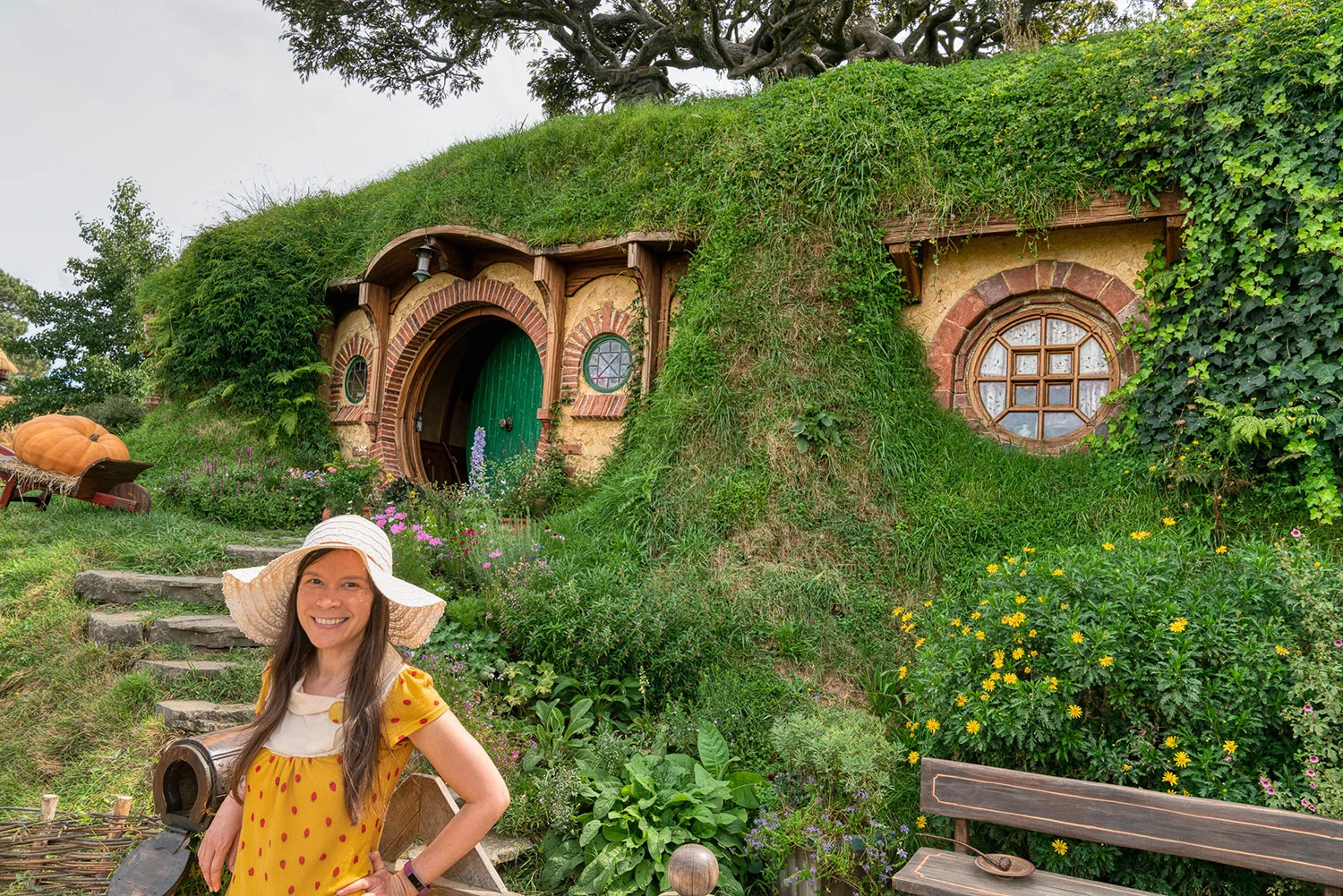 Thaneeya McArdle in front of a Hobbit house in Hobbiton