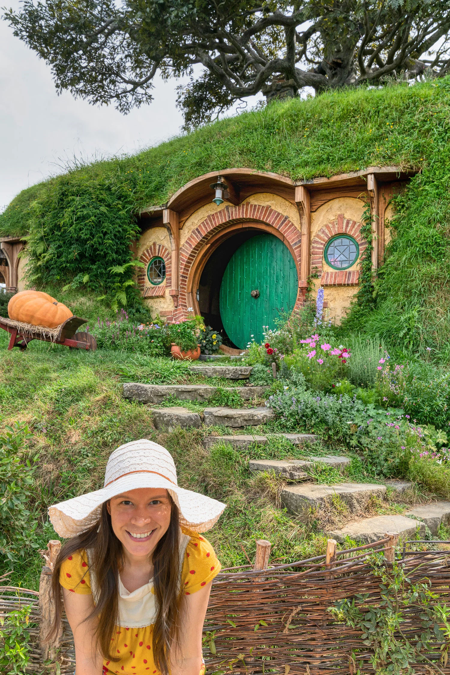Thaneeya McArdle in front of a Hobbit home in Hobbiton, Matamata, New Zealand