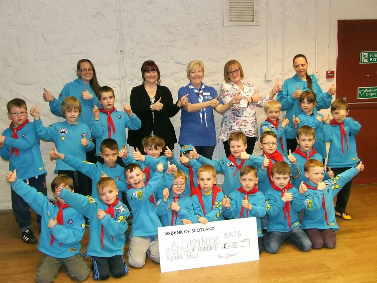 Receiving our cheque from the beavers . 