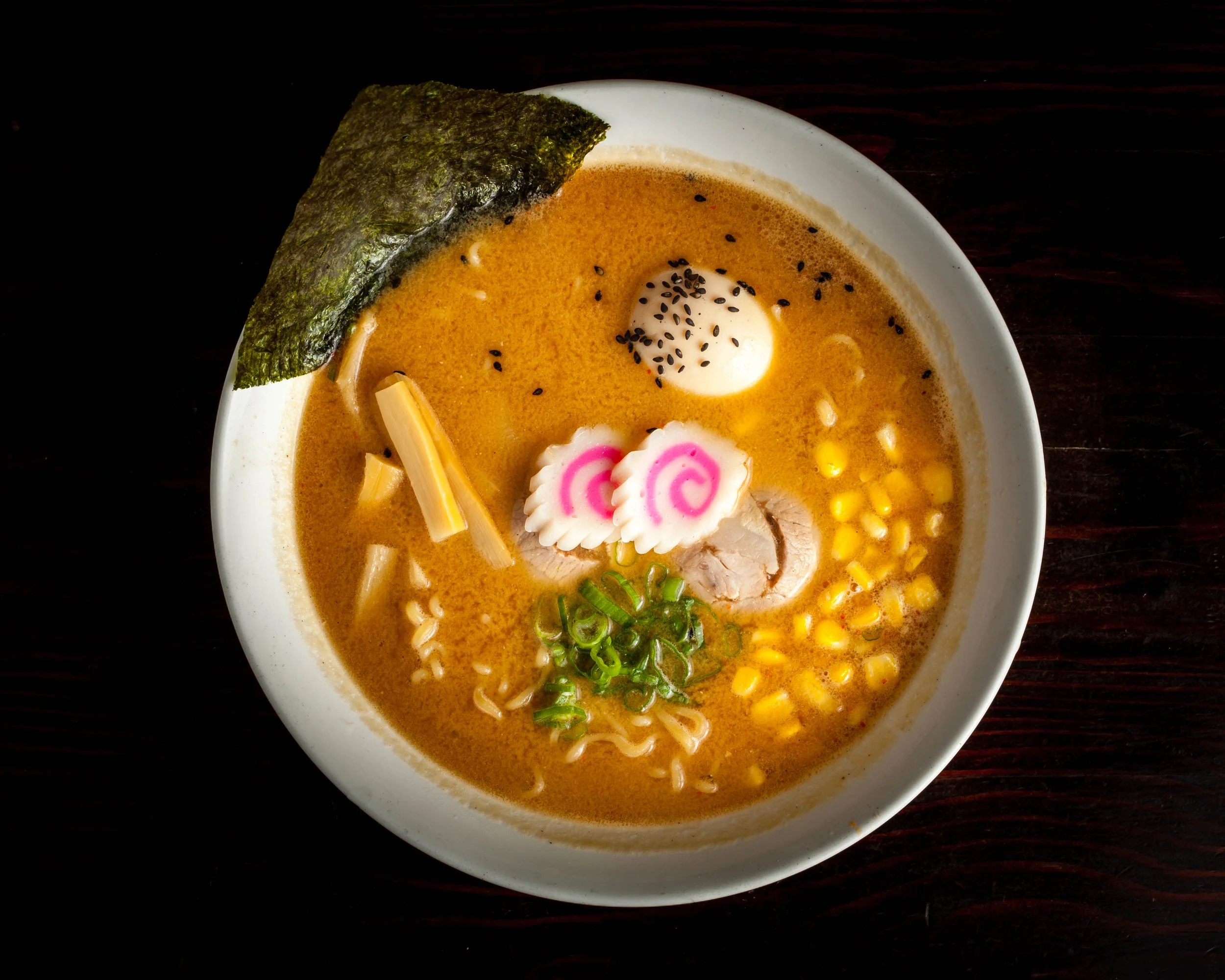 Miso Ramen Mild Spicy Miso Flavor Broth (Light Brown Color), Chashu (Pork Slices), Ajitama (Marinated Soft Boiled Egg), Bamboo Shoots, Green Onion, Corn, Naruto Fish Cake & Dry Seaweed (Miso broth contained: Sesame, Soybean)