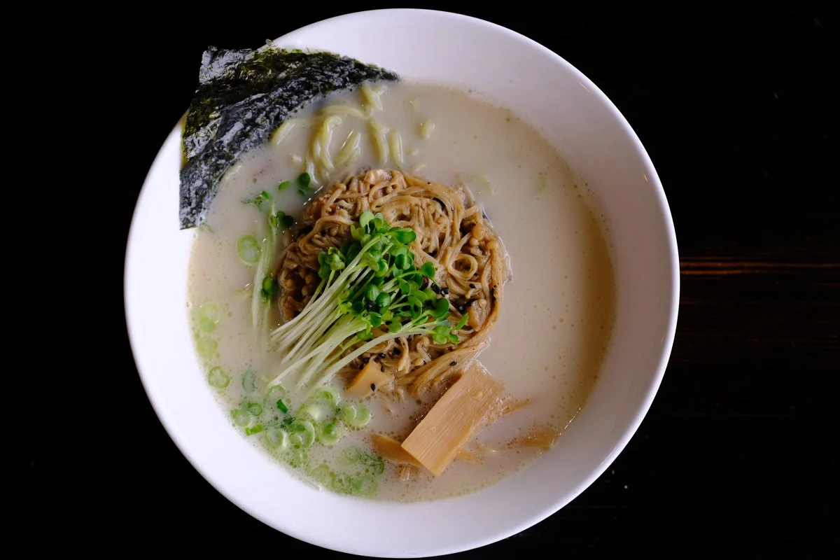 Vegan Ramen Creamy Miso broth, Sautéed Mushroom in Garlic Vegan Butter Sauce, Spinach Noodles, Radish Sprouts, Namboo Shoots, Green Onion, Dry Seaweed
