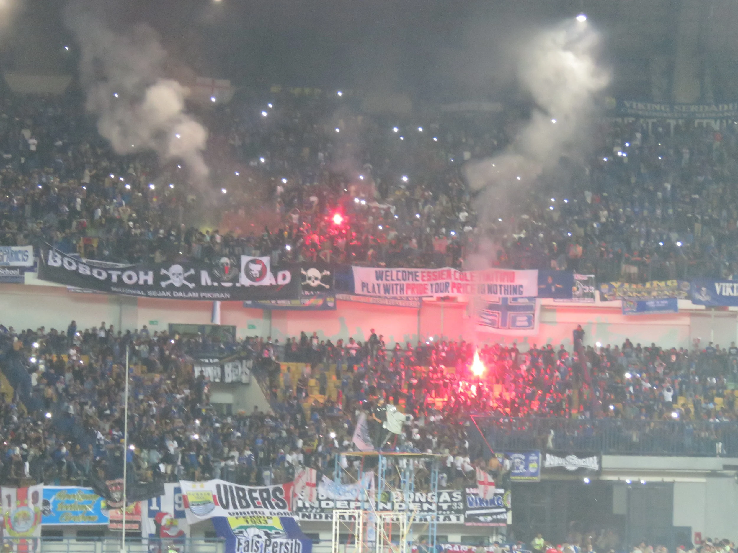 Post-match flares. Note the banner about Essien and Cole