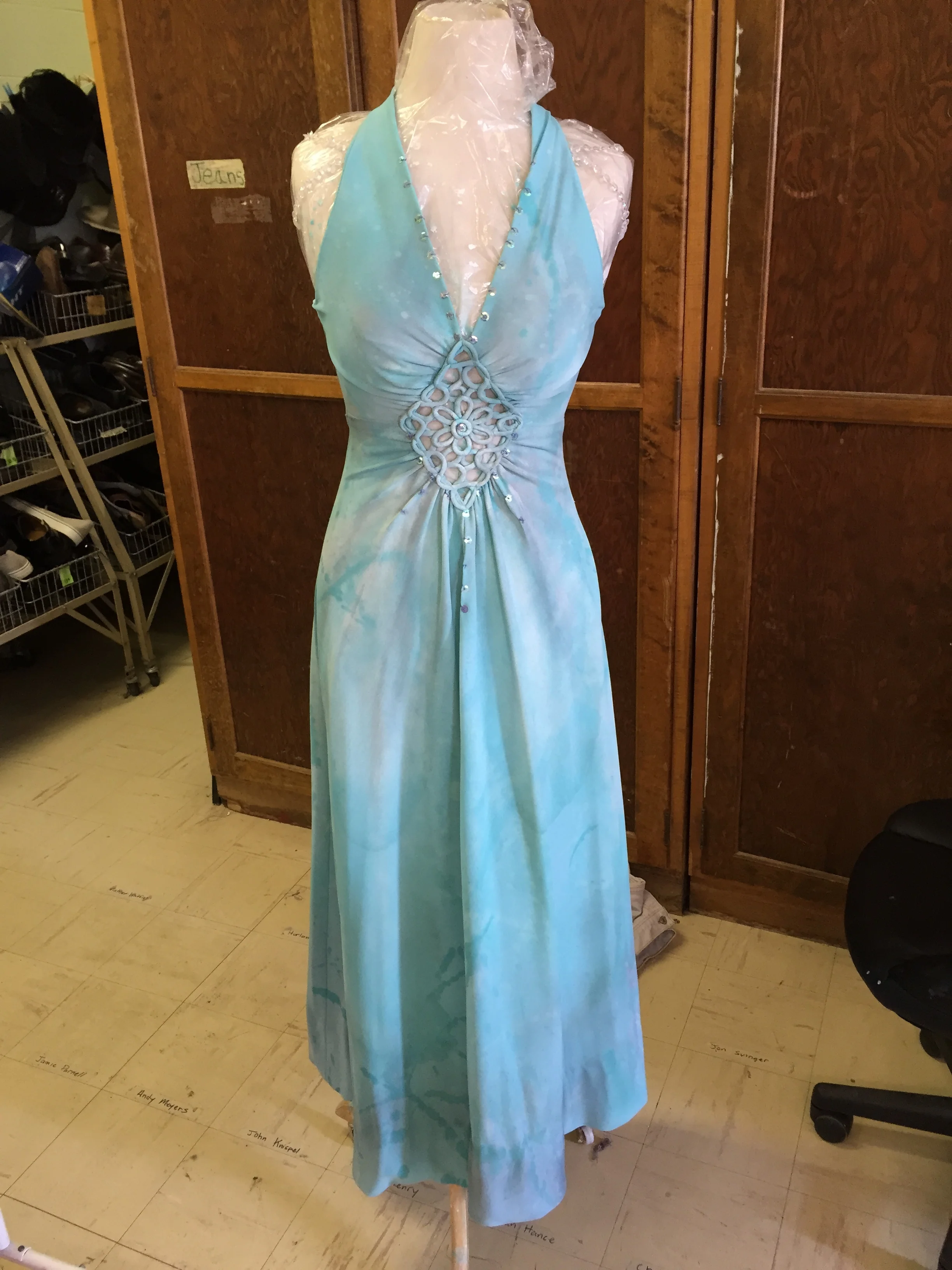 This dress was found in costume stock distressed with mud, paint, and dirt. We treated it with washes of paint to hide the distressing and give the dress a marble appearance. 
