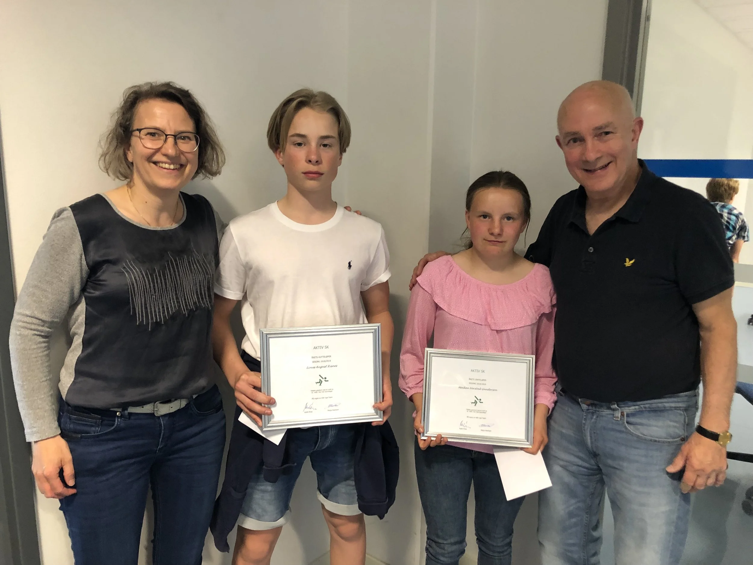 Linus Risnes og Maiken Gundersen med premiene som beste gutte- og jenteløper, omkretset av Ligaens Marja Haartsen og Keith Price.