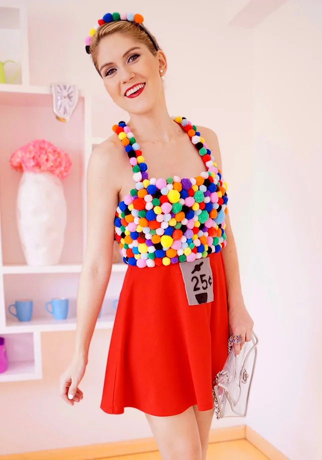 Bubble Gum Machine : This may look complicated, but it’s actually deceptively easy. All you need is a red skirt, a big bag of colored pom poms and a shirt to glue them too. (via The Joy of Fashion )