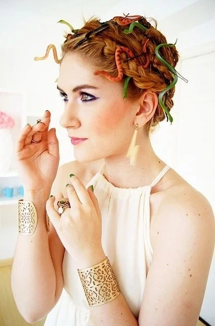 Glue toy snakes onto bobby pins and add to your hair for a last-minute Medusa look. Wear some gold accessories and a long, flowy dress for the full effect. ( via The Joy of Fashion Blog )