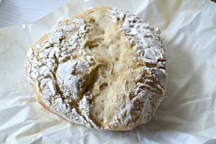 No-Knead Artisan Style Dutch Oven Bread - The bread is super crunchy on the outside, but moist and soft on the inside! I buttered it and was in heaven! Get the recipe!