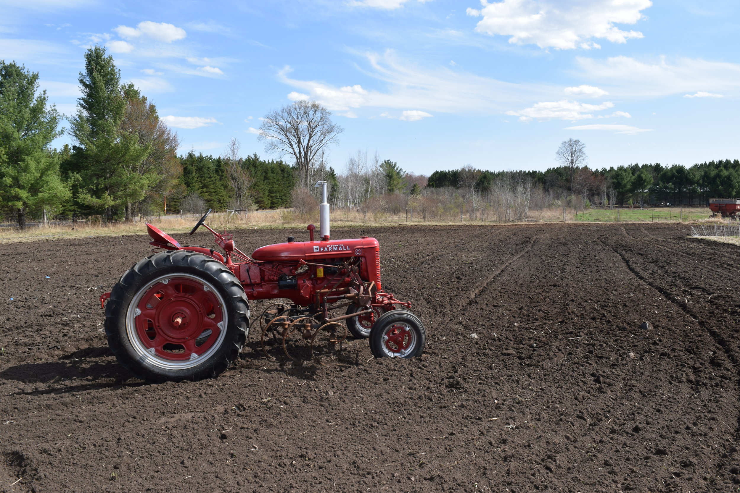 Red tractor in the plowed field.JPG