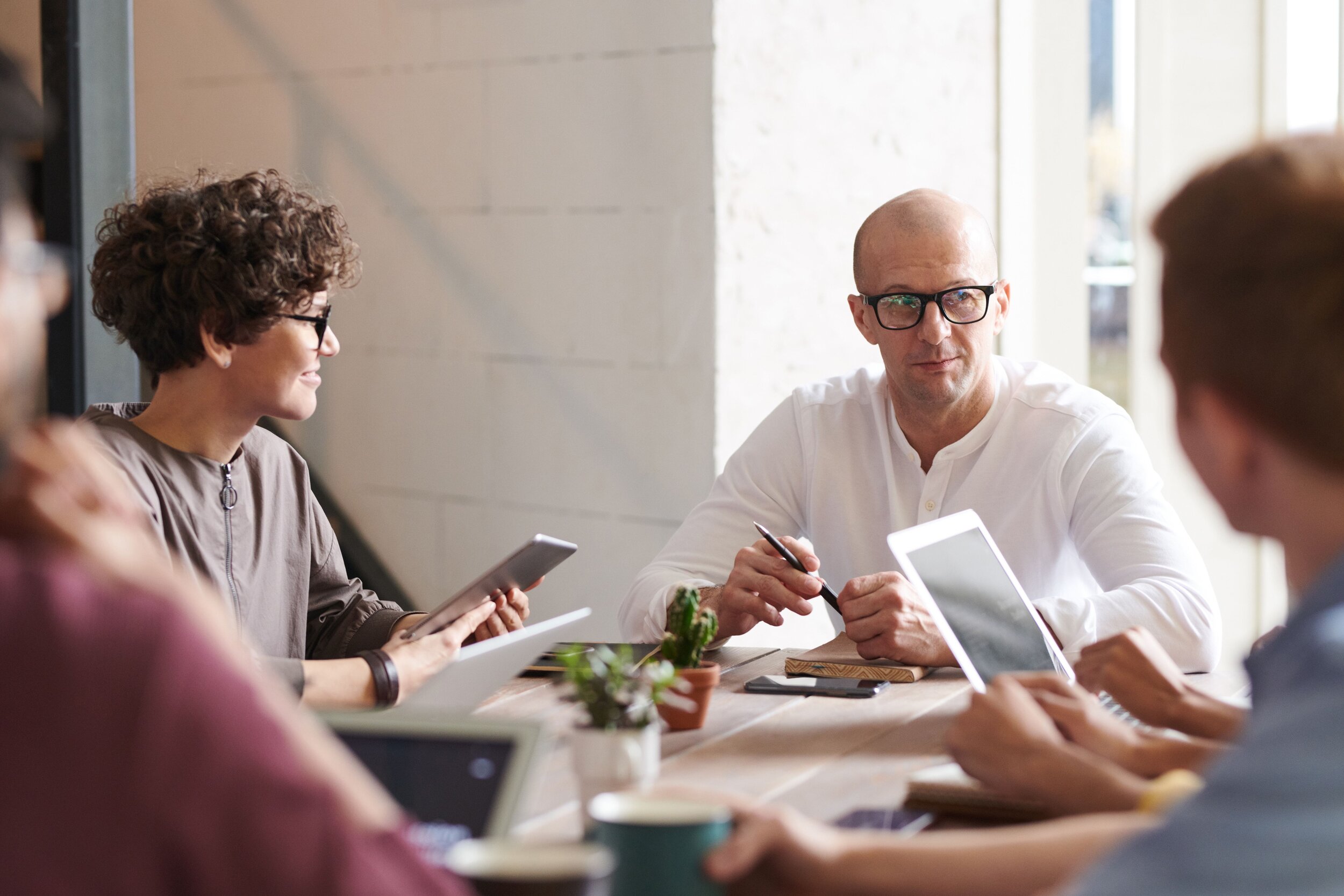 photo-of-man-sitting-in-front-of-people-3184299.jpg