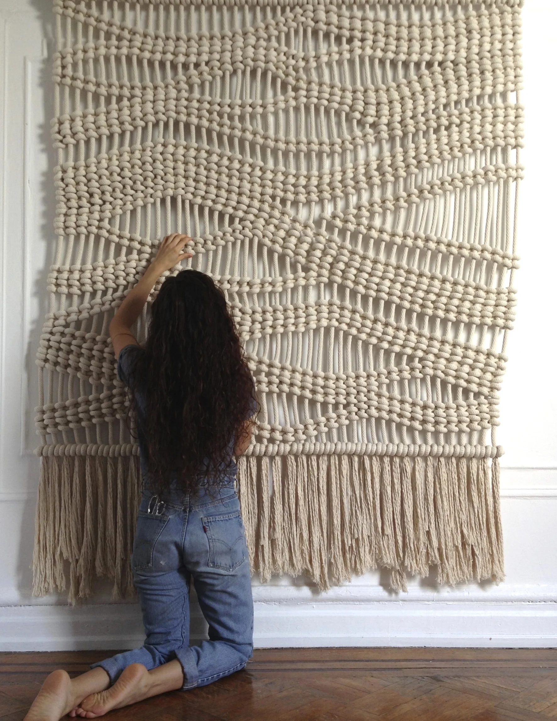 WANDERING MACRAME WALL HANGING WITH FRINGE A THICK NAUTICAL ROPE DESIGN IS PEFECT FOR A BEACH HOUSE OR RESORT. ORGANIC CURVES CREATE A FEELING OF MOVEMENT. 6' WIDE X 7' HIGH, 100% COTTON, 3/4" ROPE FOR PRICING CLICK HERE , FOR CUSTOM SIZES, ORDERS AND INQUIRIES PLEASE USE THE CONTACT FORM.